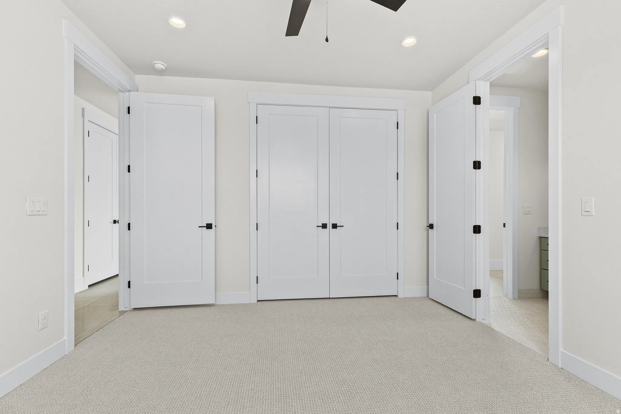Unfurnished bedroom with light colored carpet, recessed lighting, a closet, and ceiling fan
