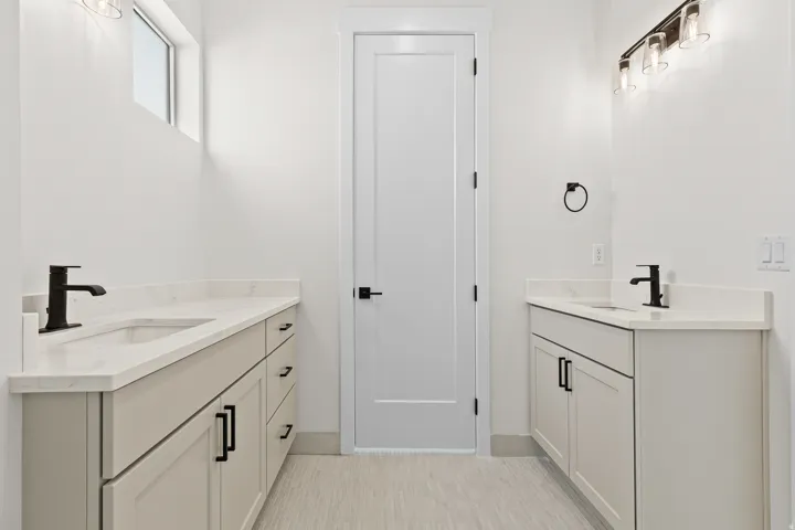 Full bath featuring two vanities