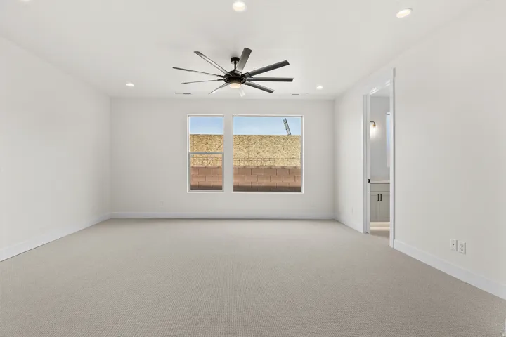 Unfurnished room featuring light carpet, a ceiling fan, and recessed lighting