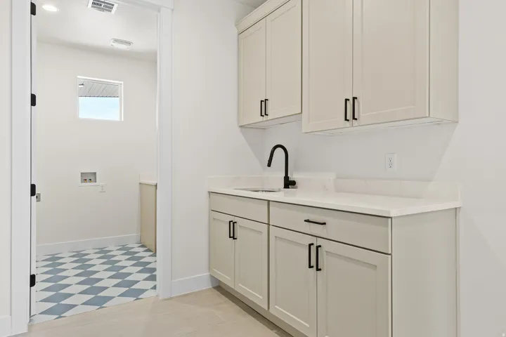 Bar area featuring baseboards and white cabinets