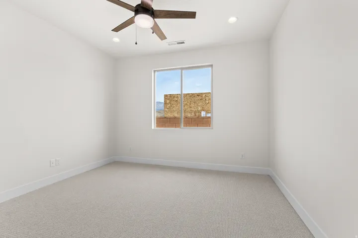 Spare room with light carpet, ceiling fan, and recessed lighting