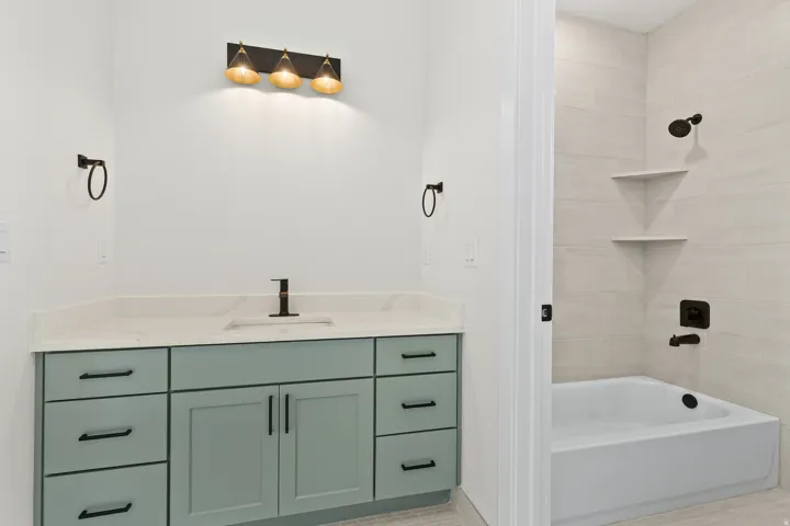 Bathroom with vanity and bathing tub / shower combination