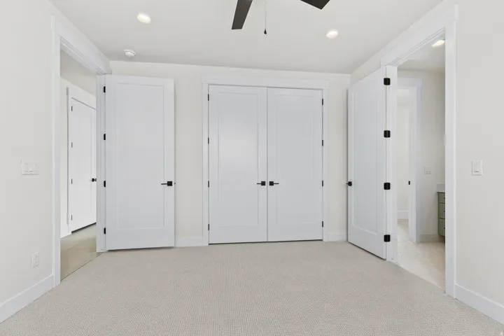 Unfurnished bedroom with light colored carpet, recessed lighting, a closet, and ceiling fan