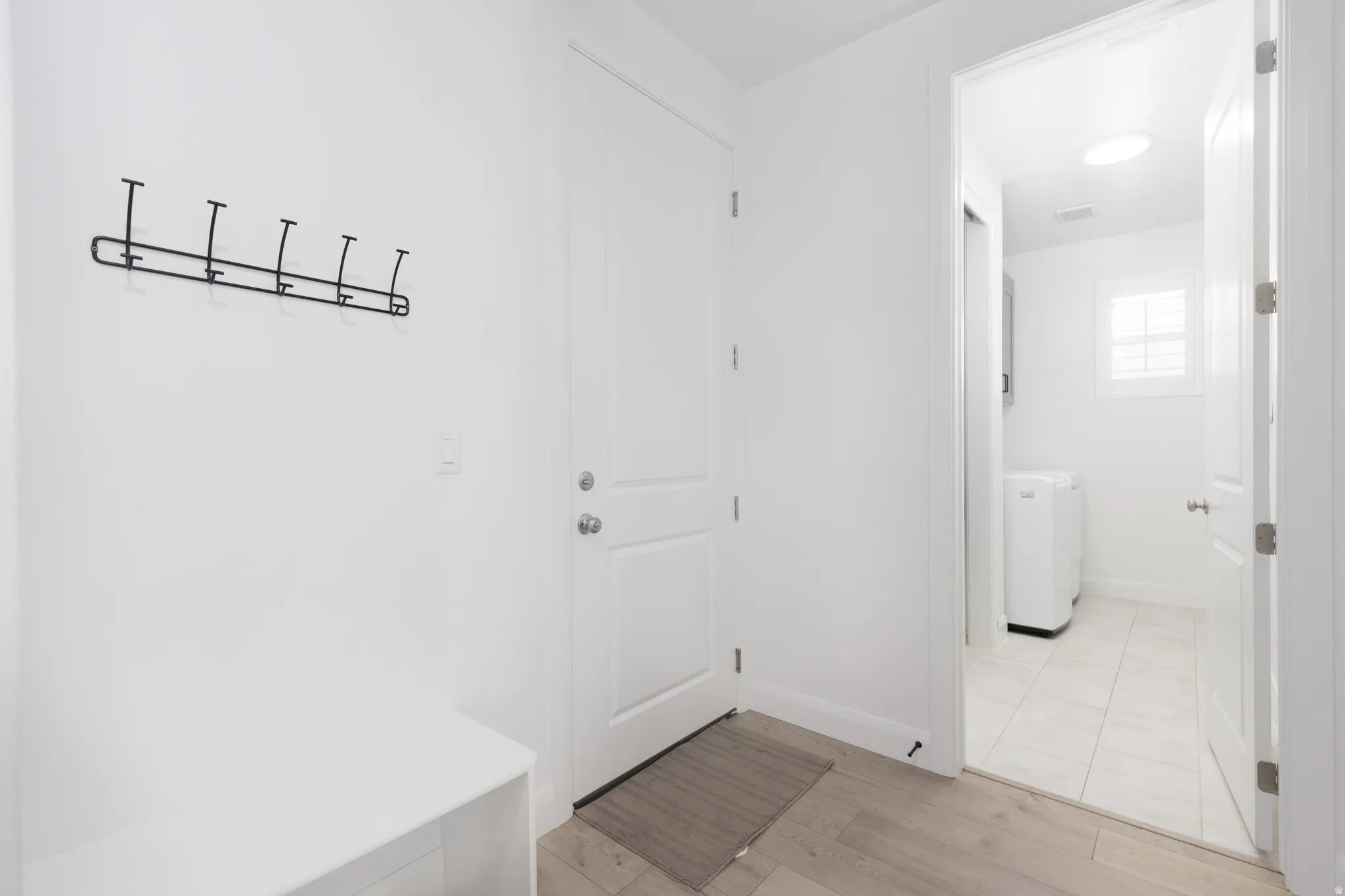 Mudroom featuring light wood finished floors and washer / clothes dryer