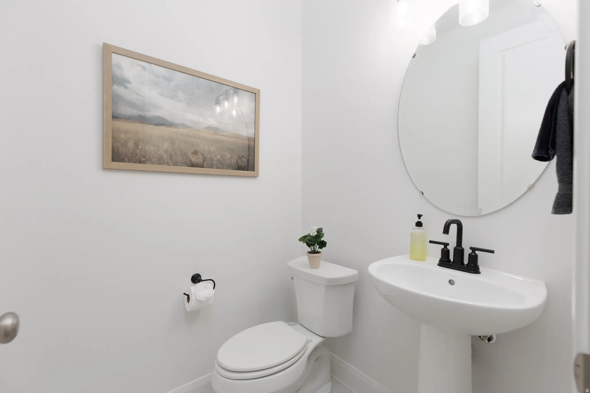 Half bath featuring toilet and baseboards