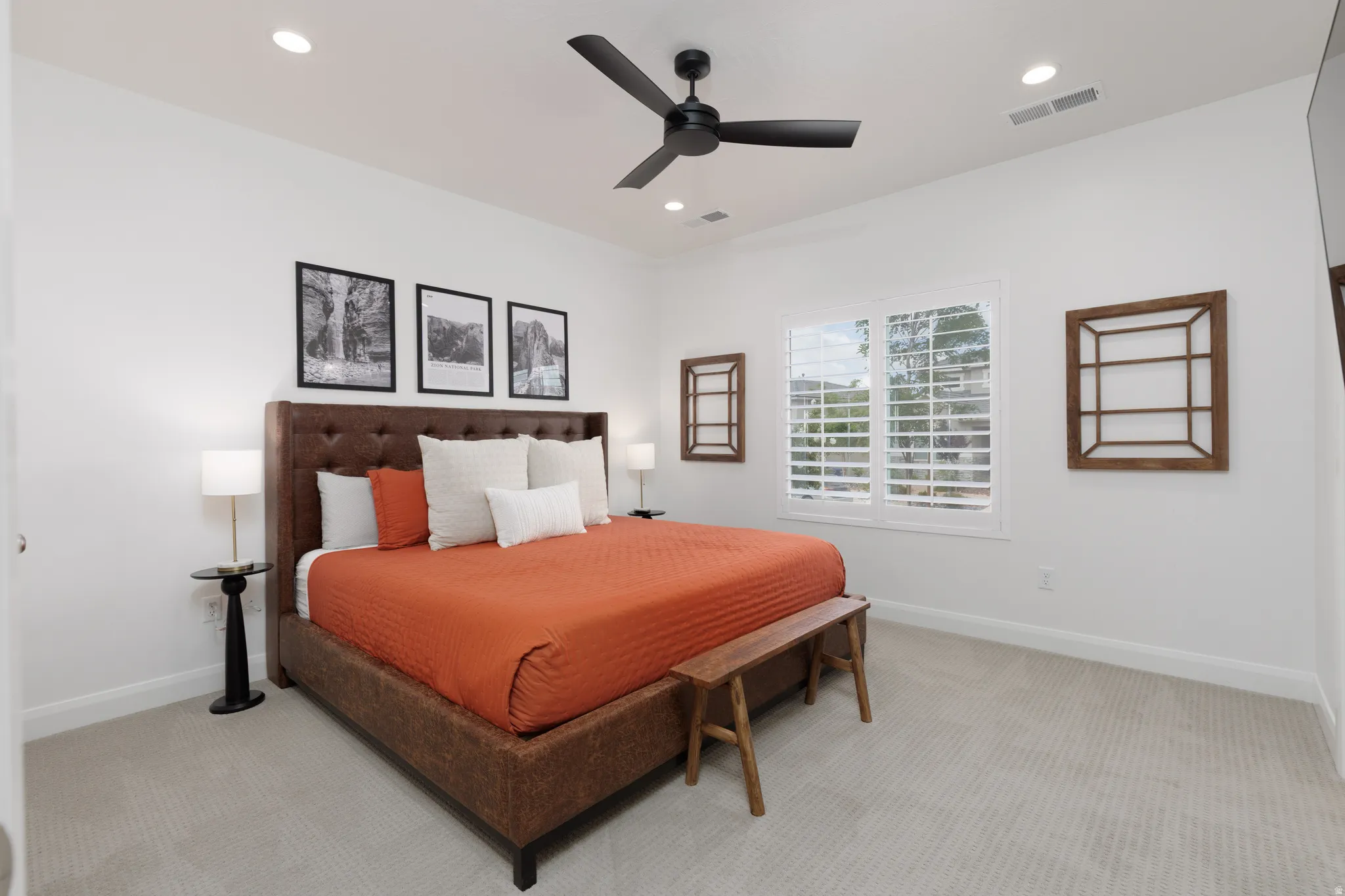 Bedroom featuring light colored carpet, ceiling fan, and recessed lighting