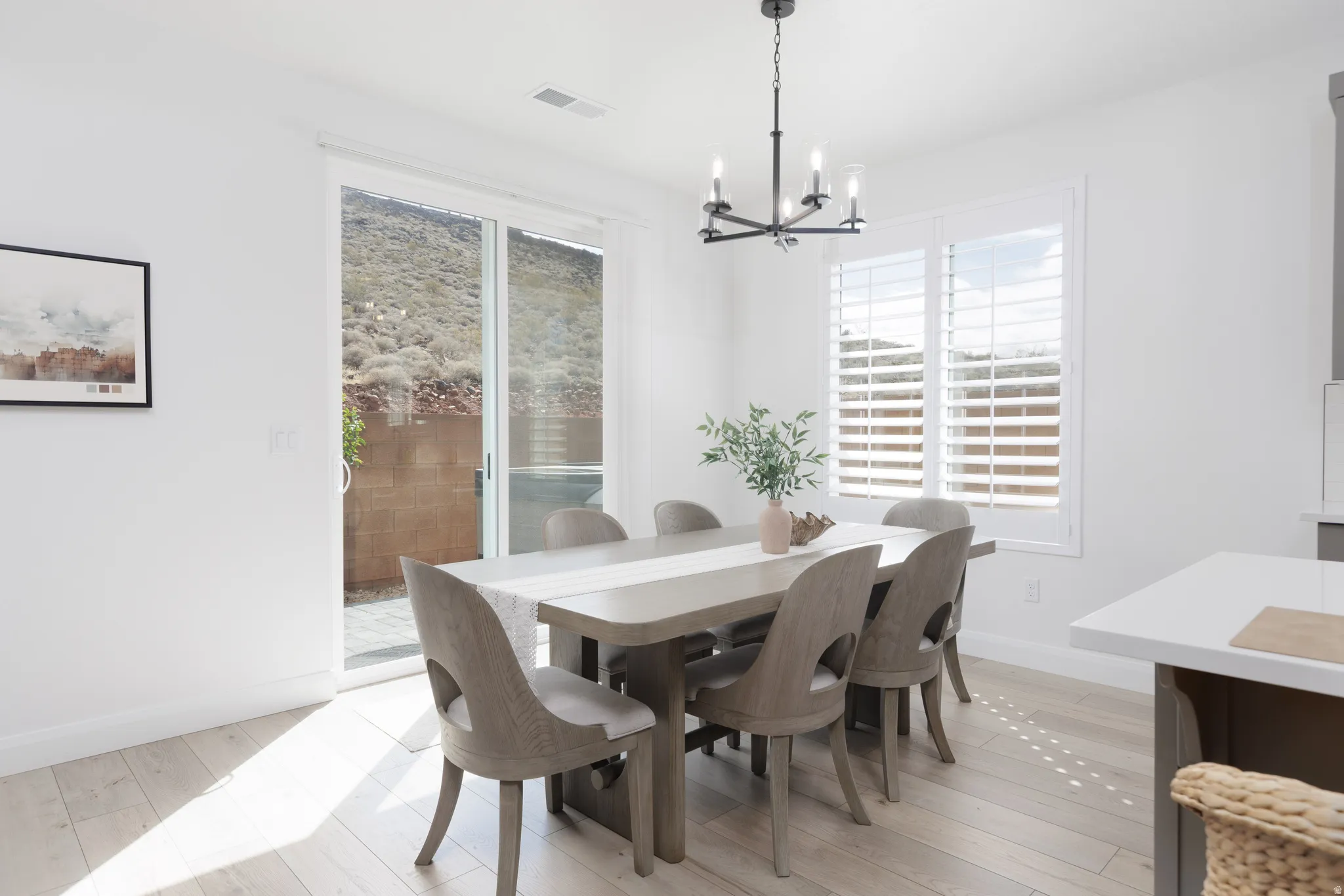 Dining space featuring suspended lighting and light wood-type flooring