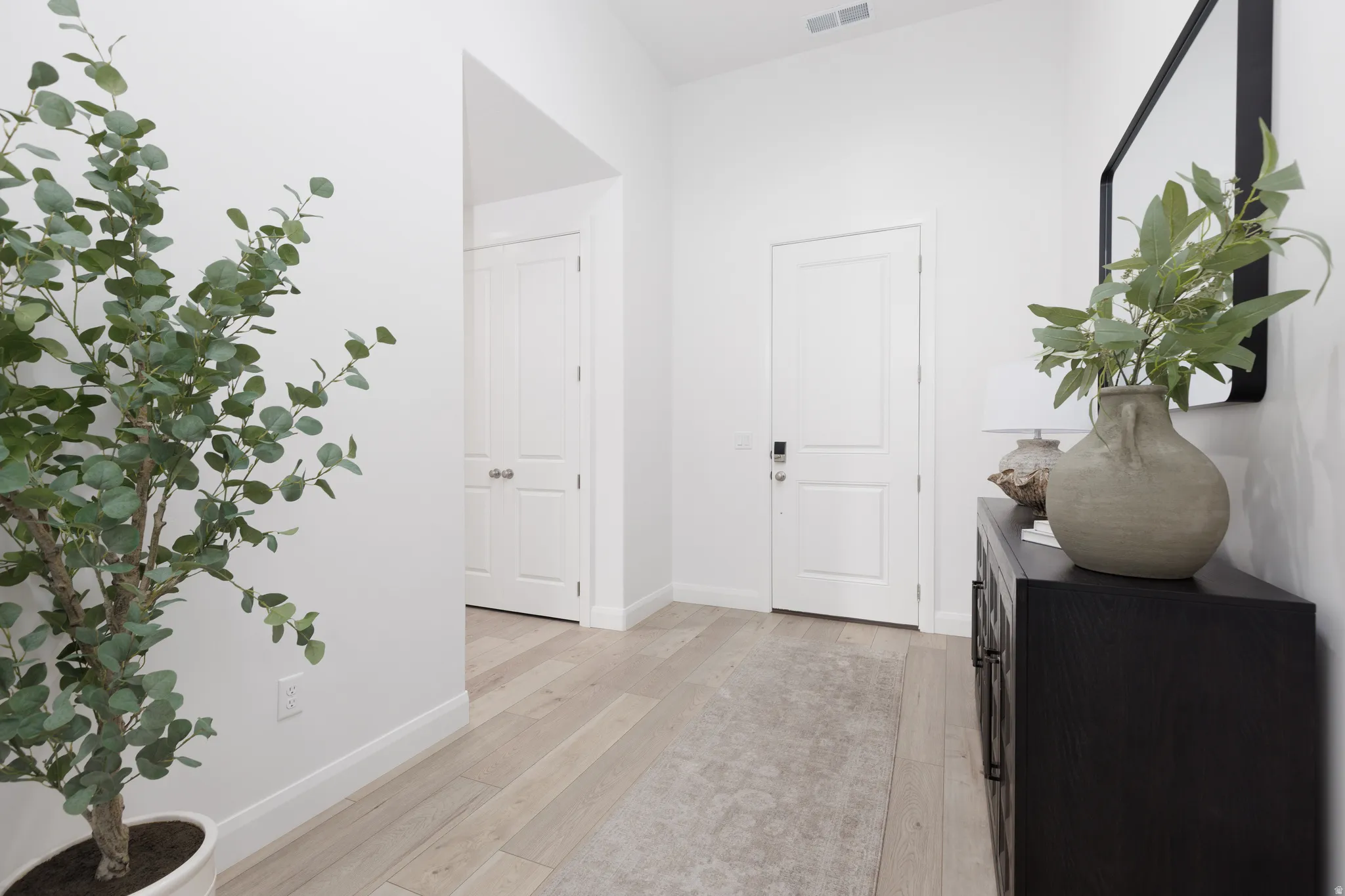 Hall featuring light wood-style floors