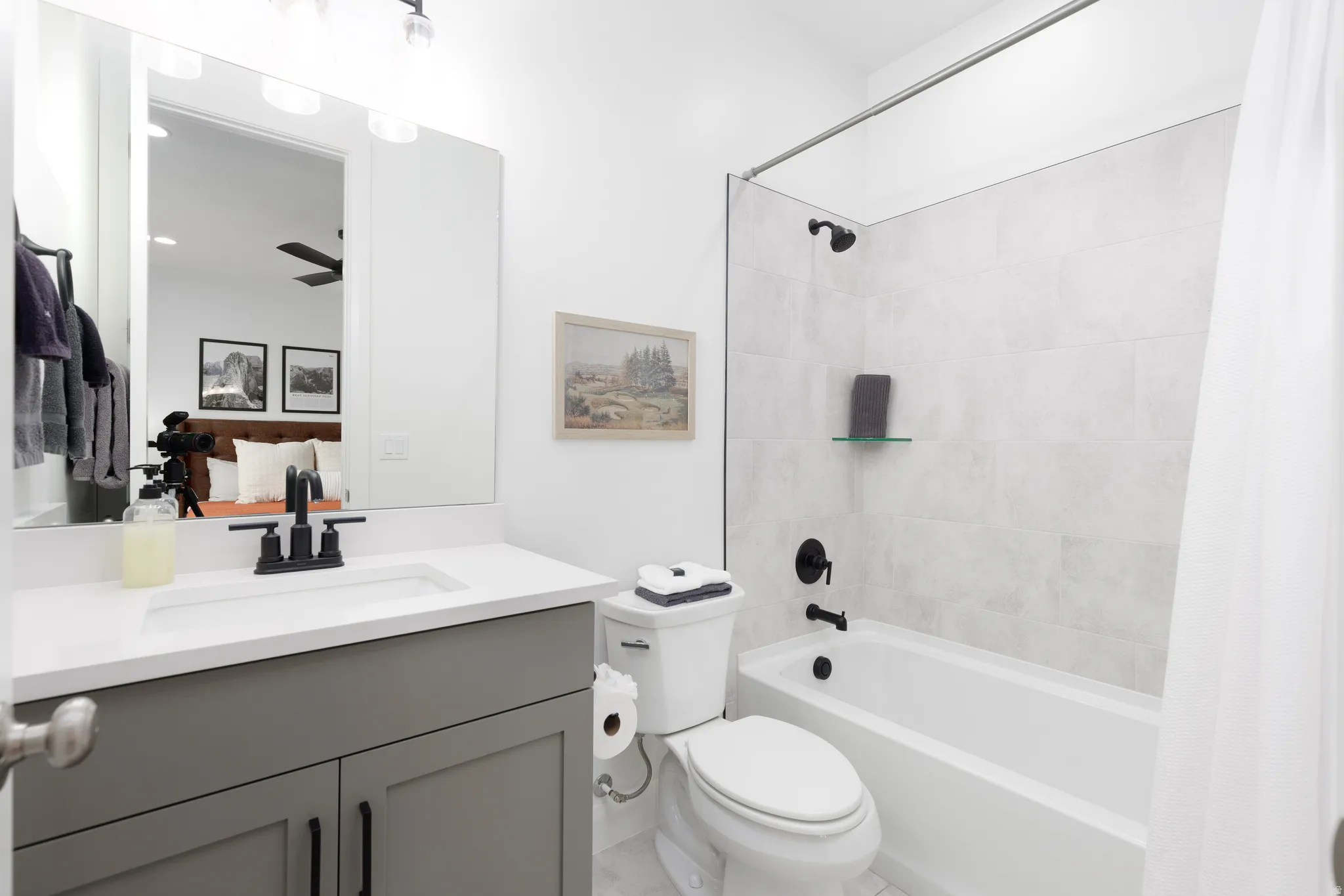 Full bath with vanity, shower / tub combo, and connected bathroom