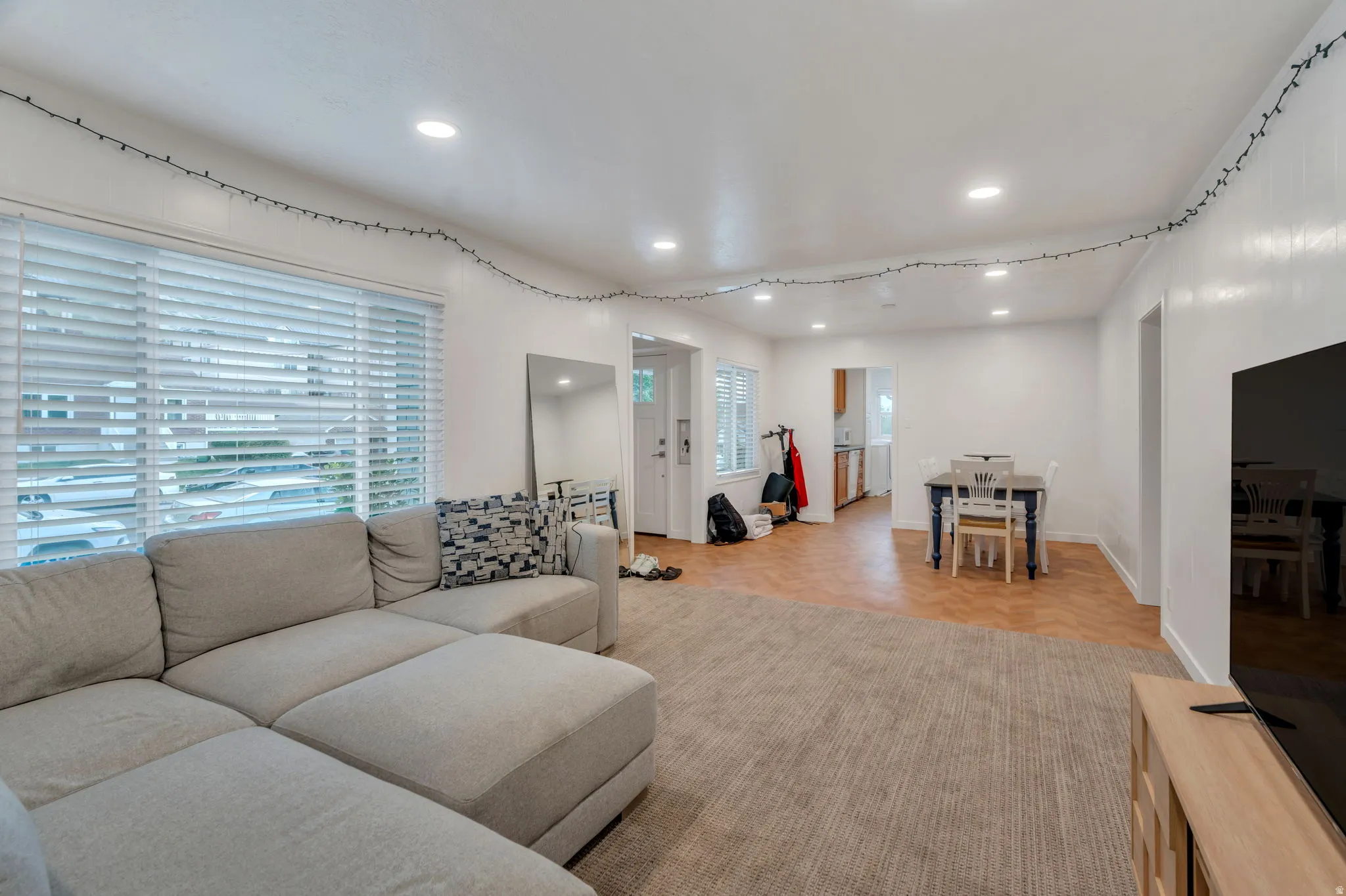 Living room has large windows and plenty of room for seating