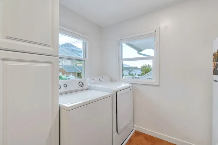 Laundry area at the end of the kitchen has lots of natural light and storage