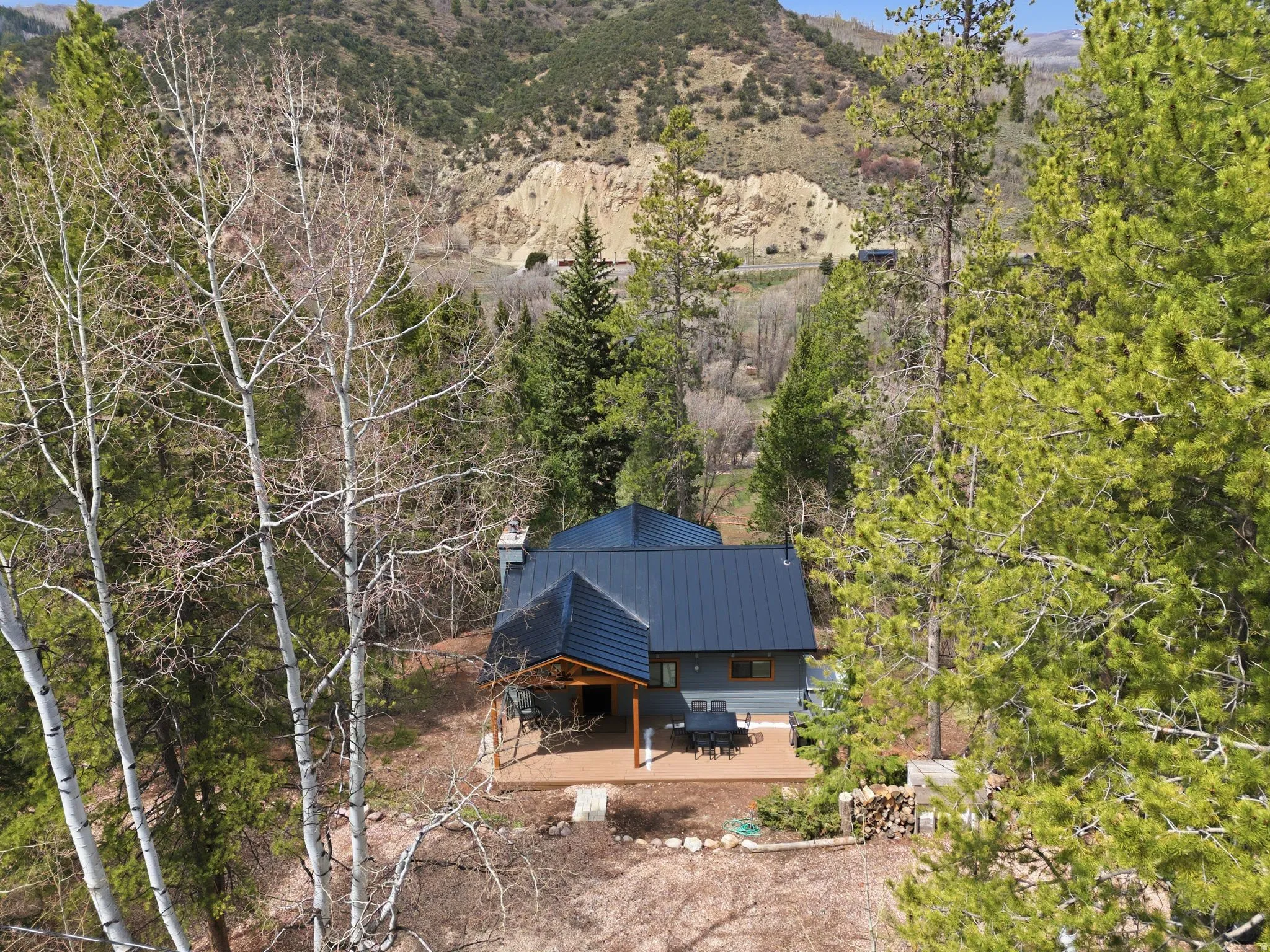 Aerial view of property and surrounding area with a mountainous background