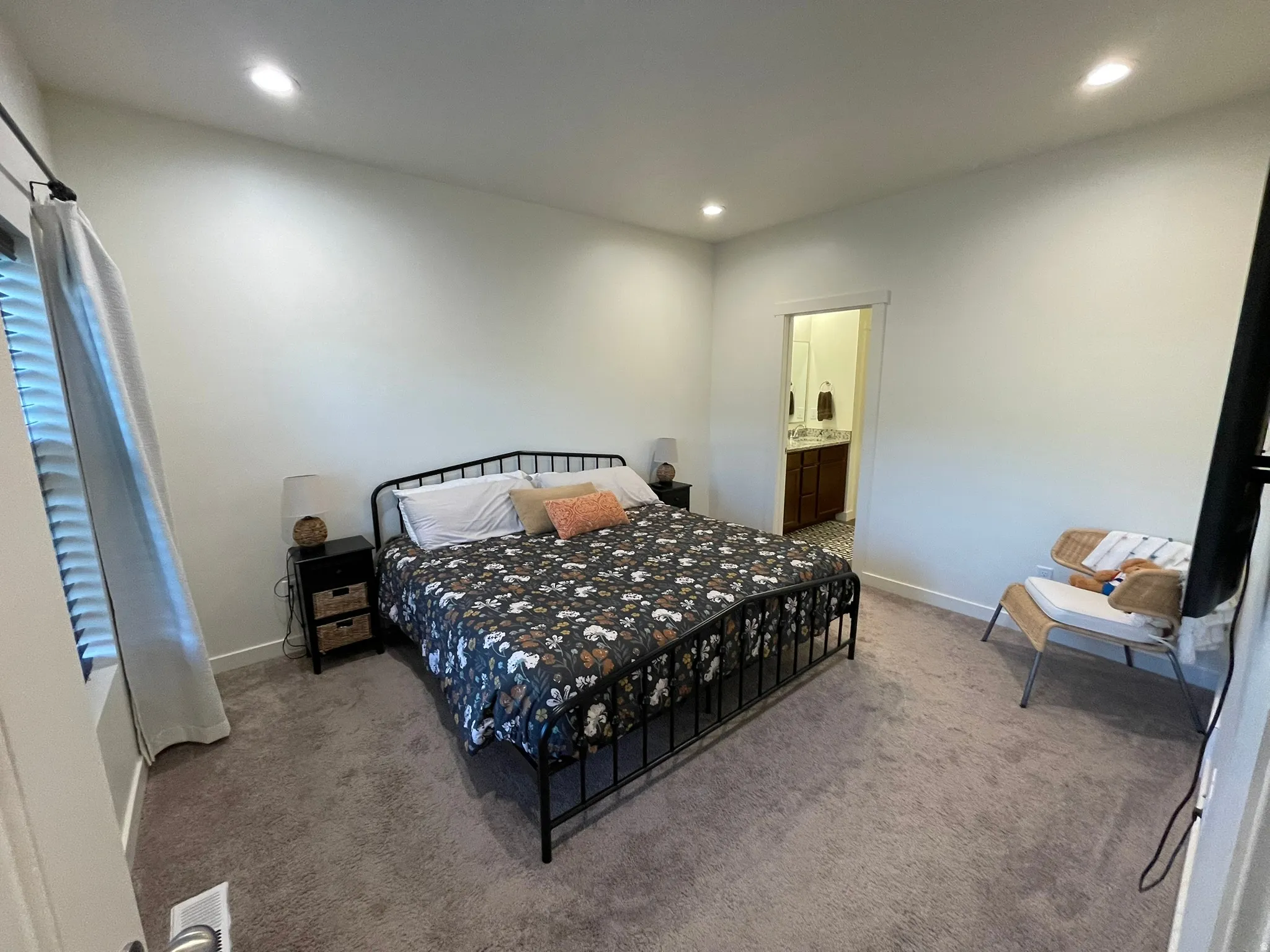 Bedroom with carpet floors, recessed lighting, and ensuite bath