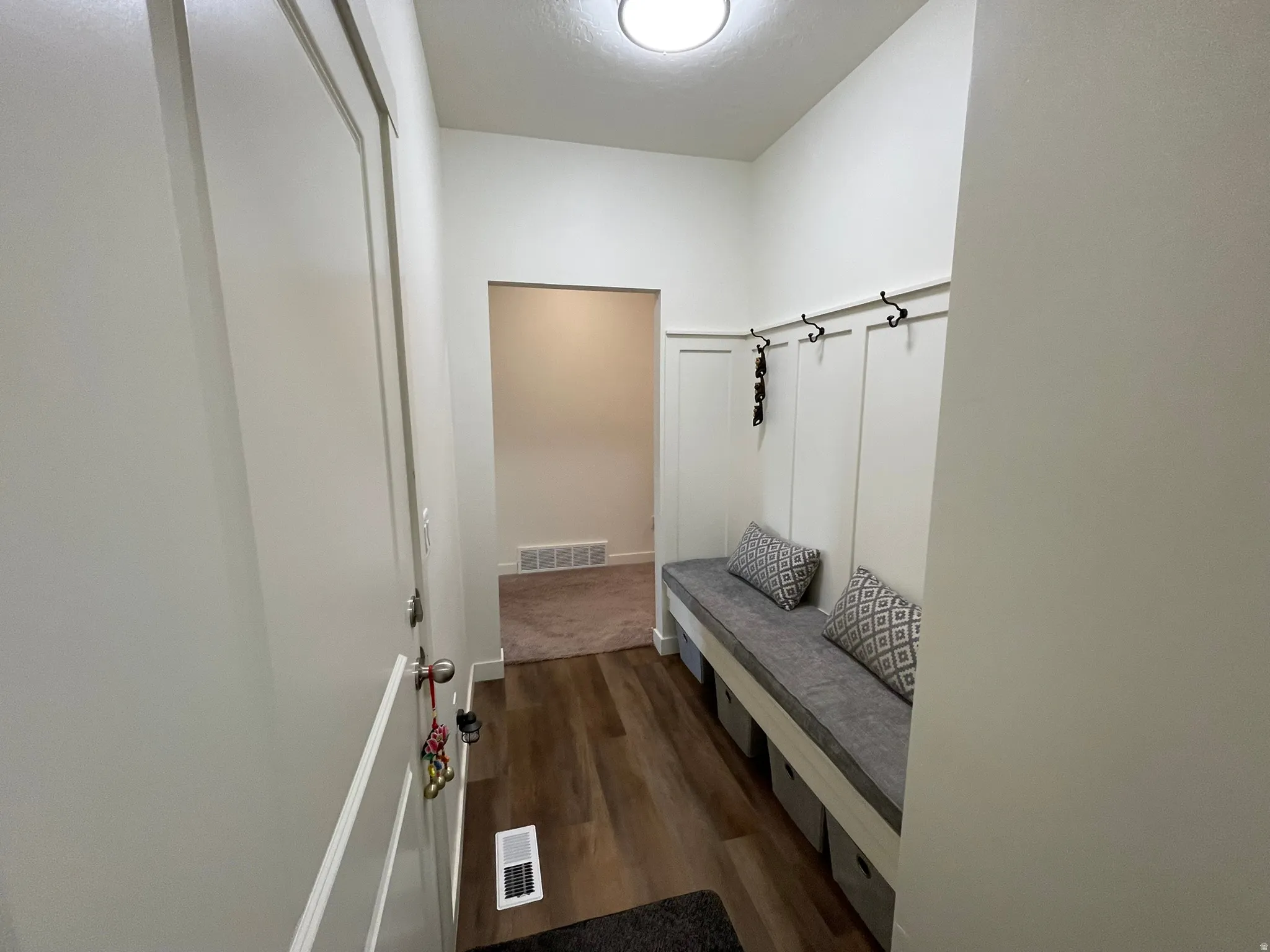 Mudroom with dark wood-style floors and baseboards