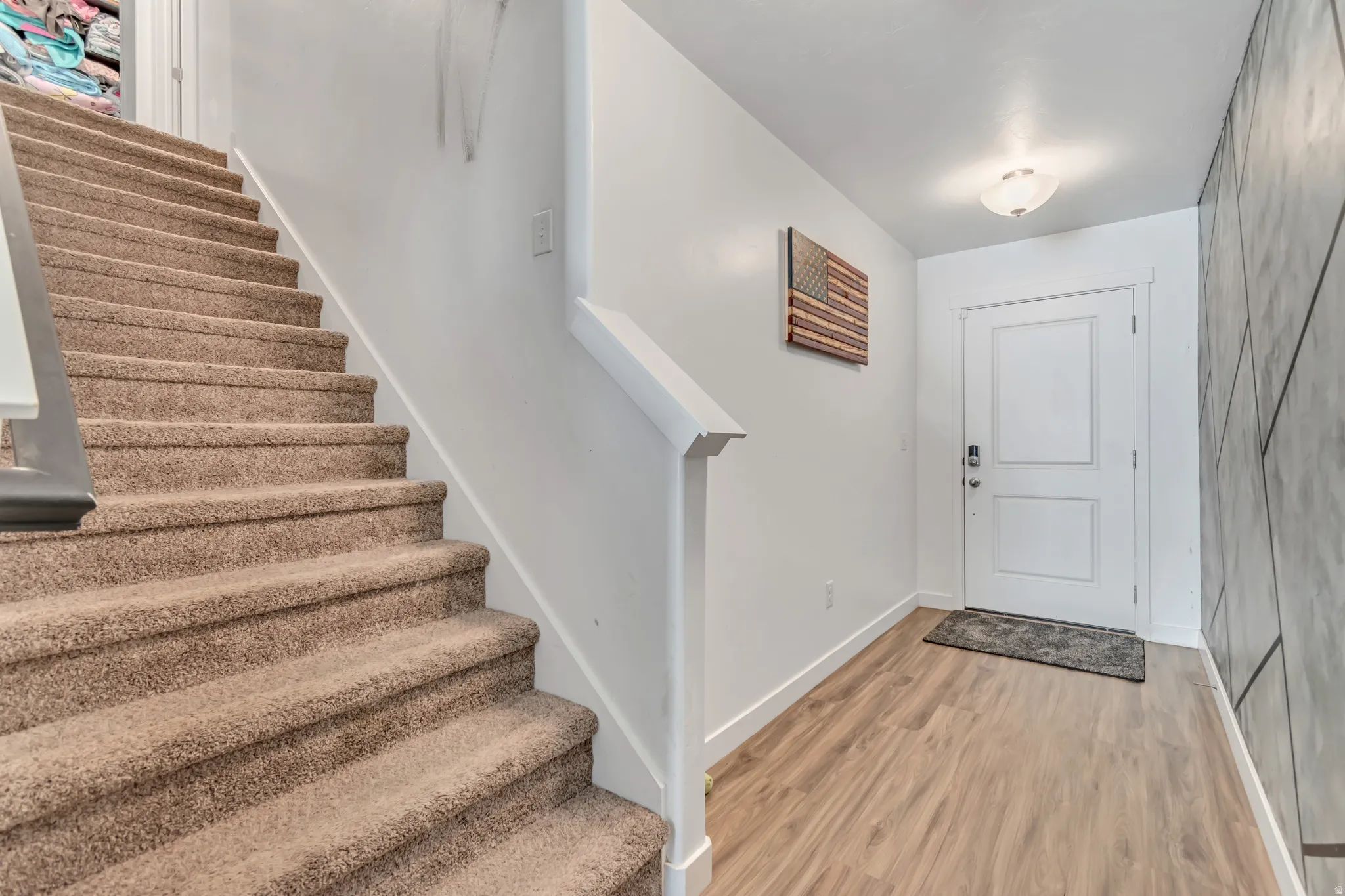 Entryway with stairs and light wood-type flooring