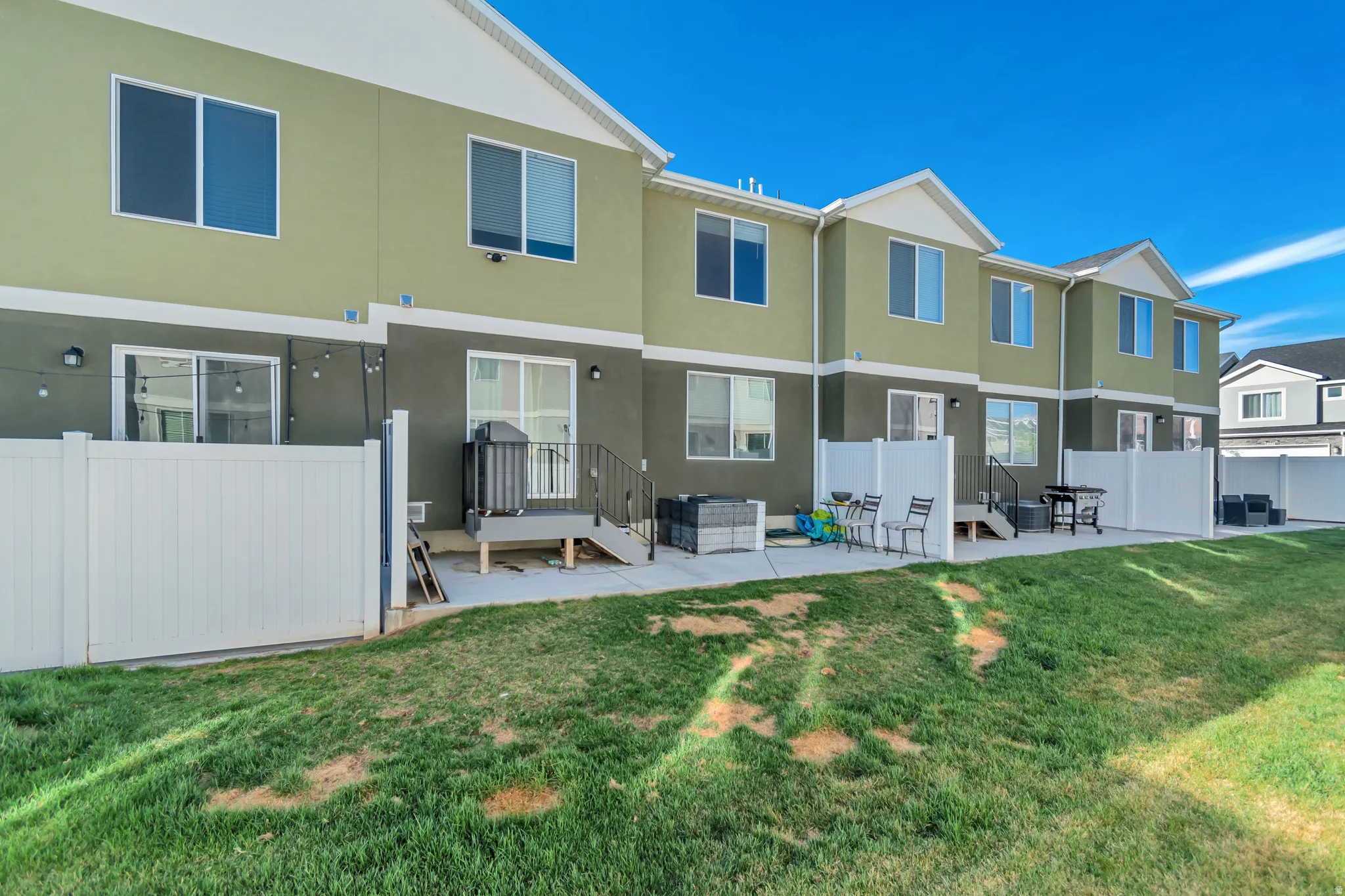 Rear view of house with a patio area and stucco siding