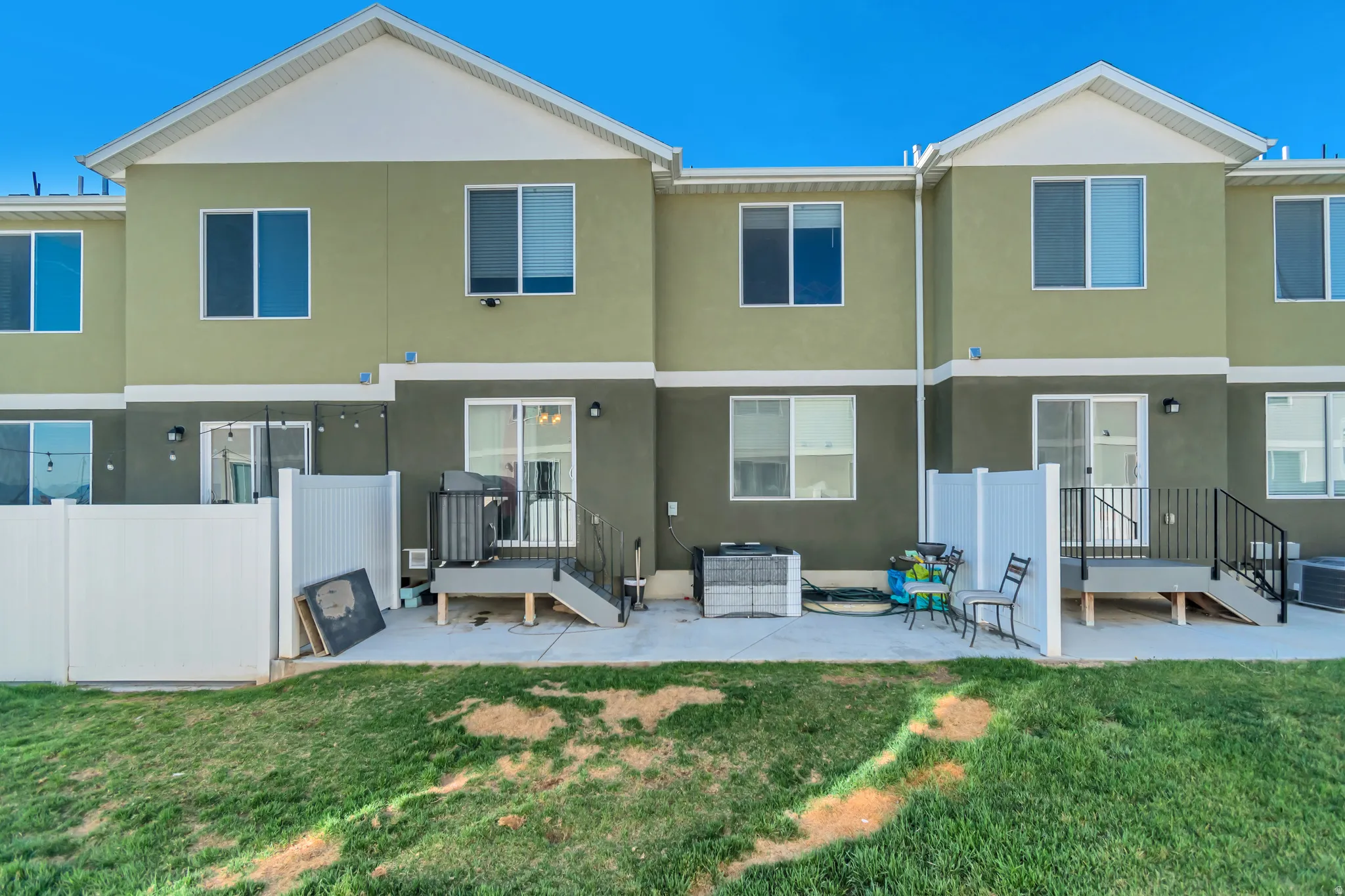 Rear view of house featuring a patio area and stucco siding