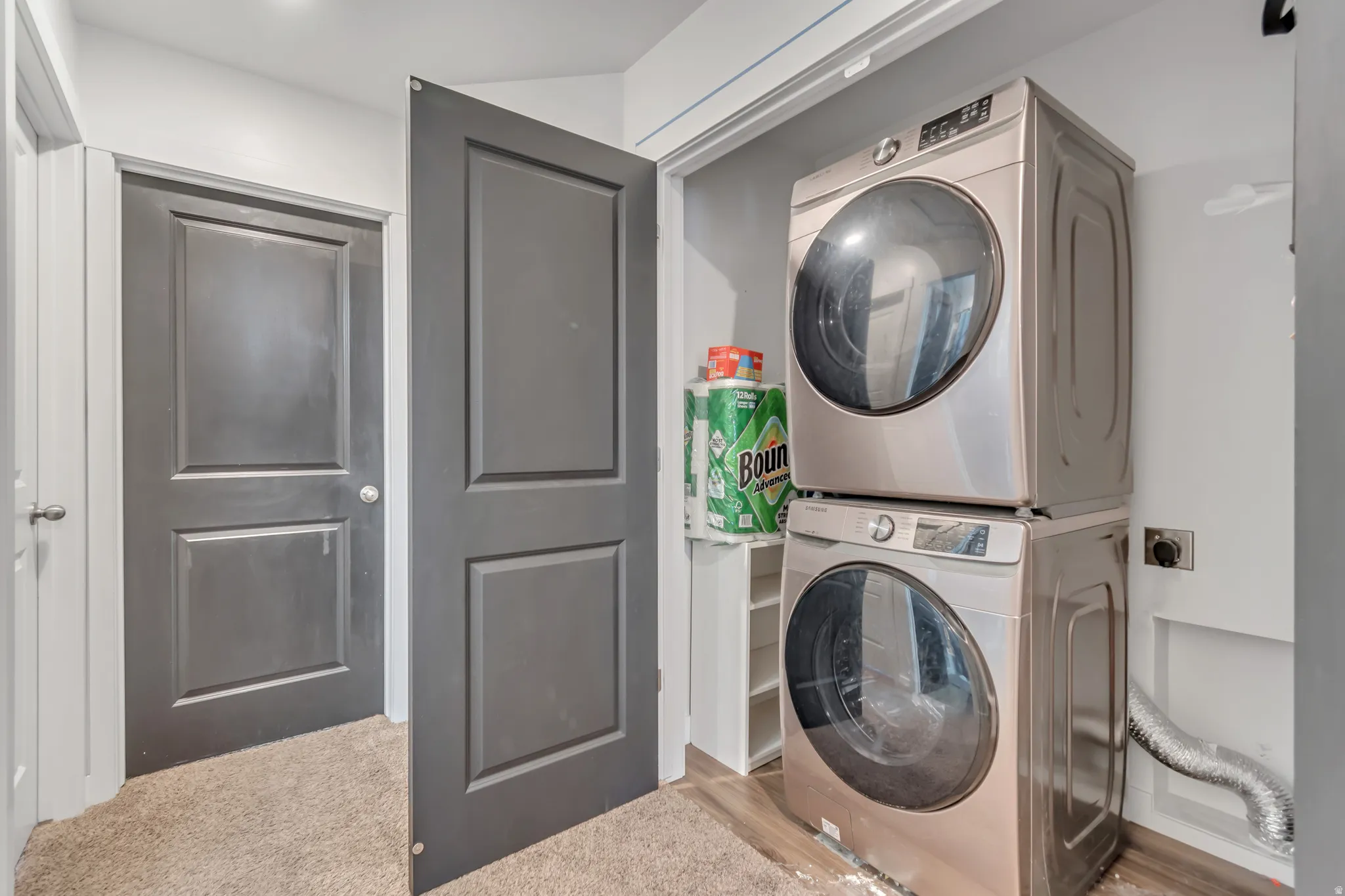 Laundry area featuring stacked washer / drying machine