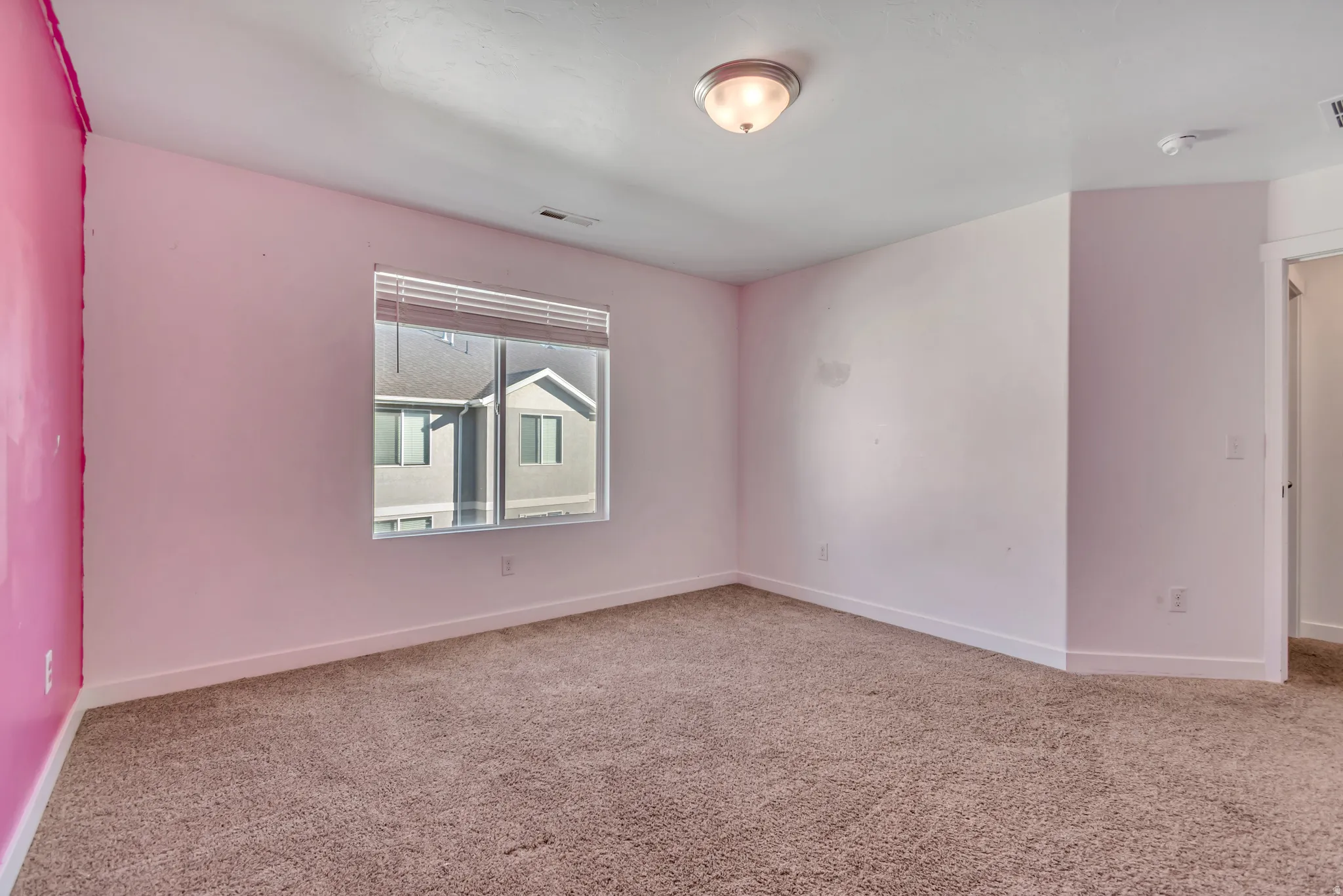 Carpeted empty room featuring baseboards