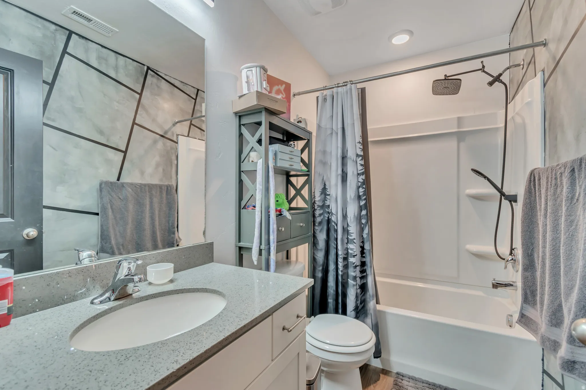 Bathroom with vanity and shower / tub combo