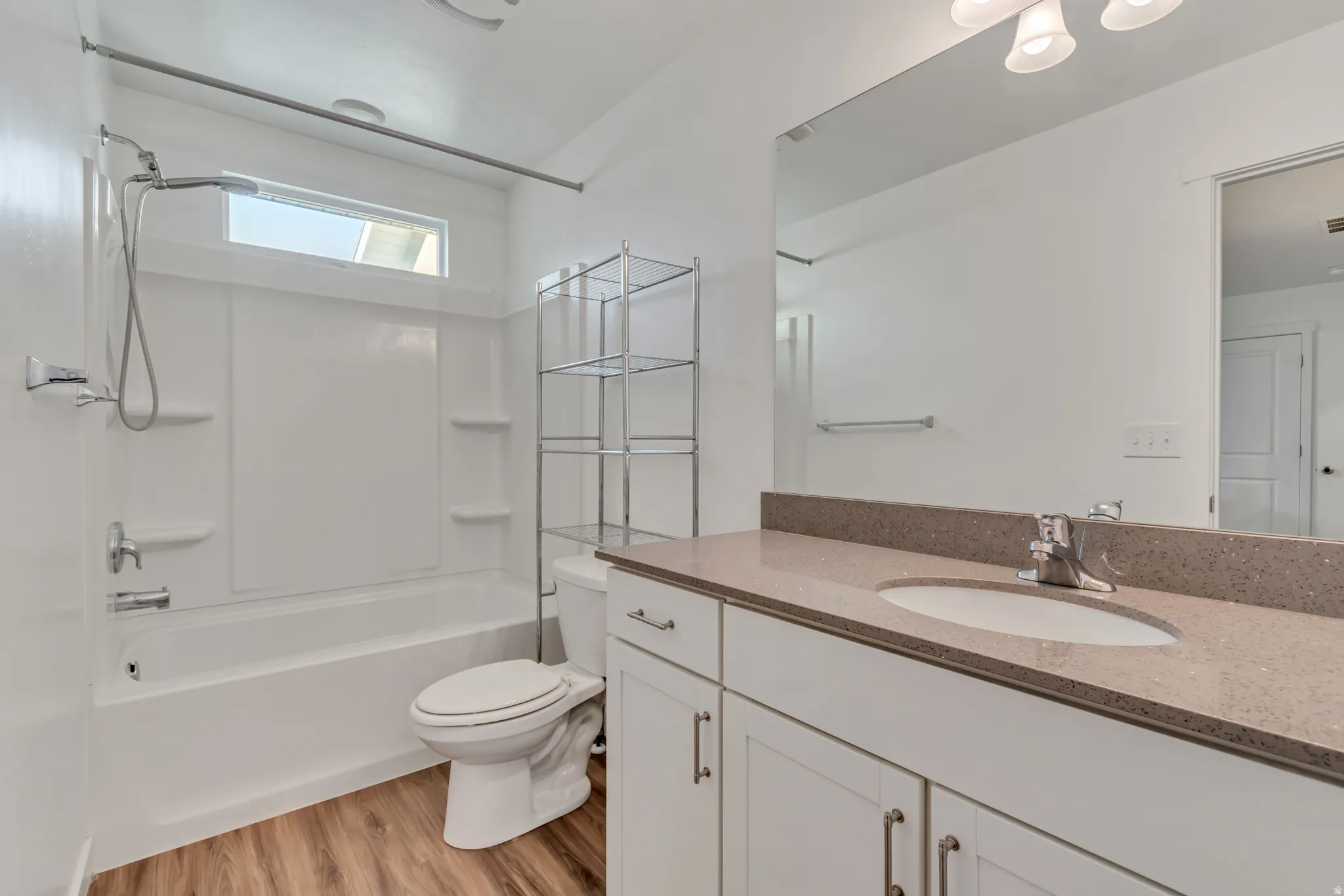 Full bathroom featuring vanity, light wood-style flooring, and tub / shower combination