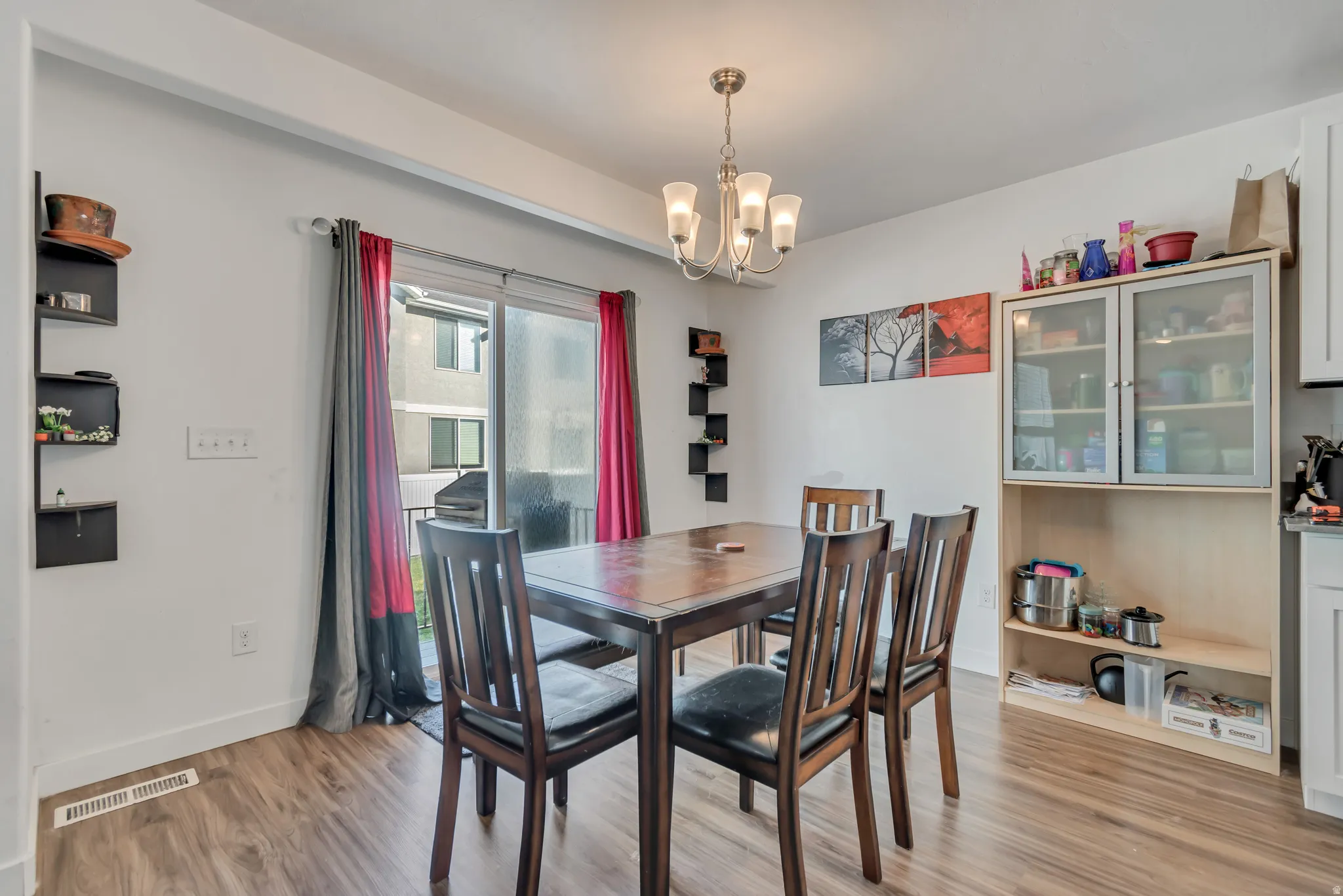 Dining room with hanging lights and light wood-style flooring
