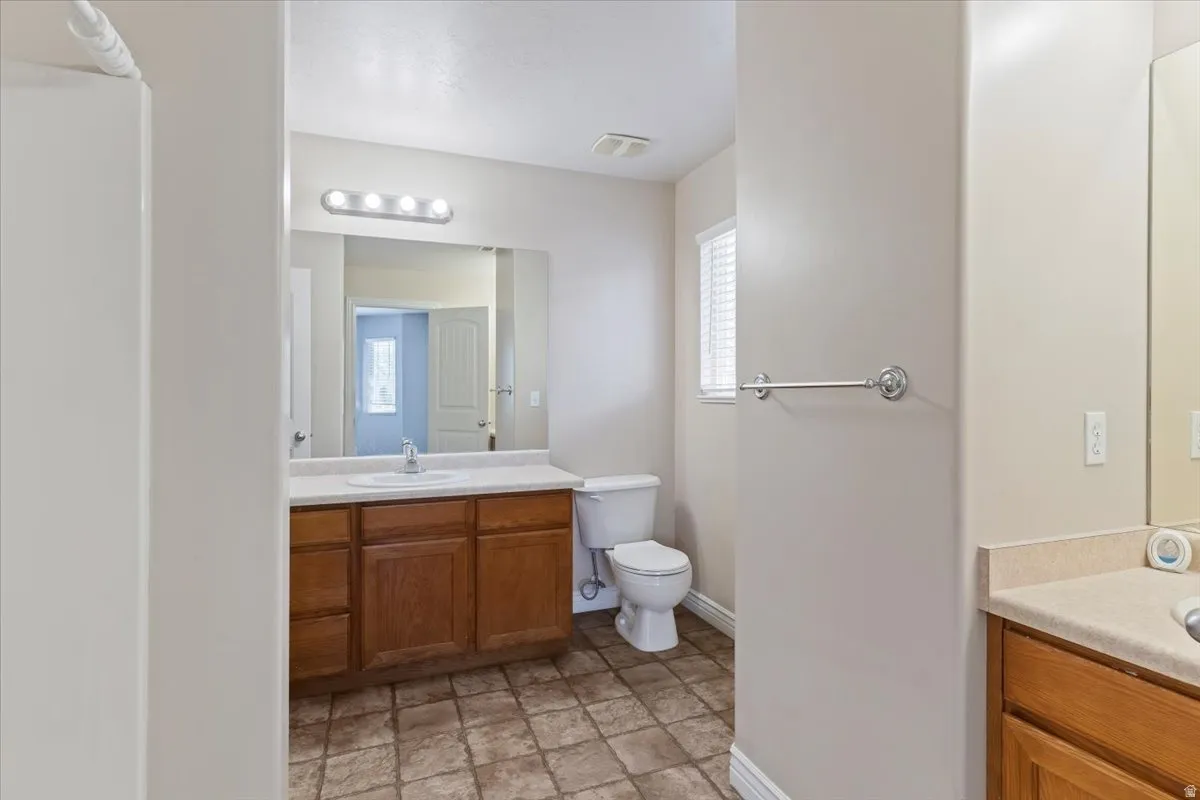 Bathroom with vanity and stone finish flooring