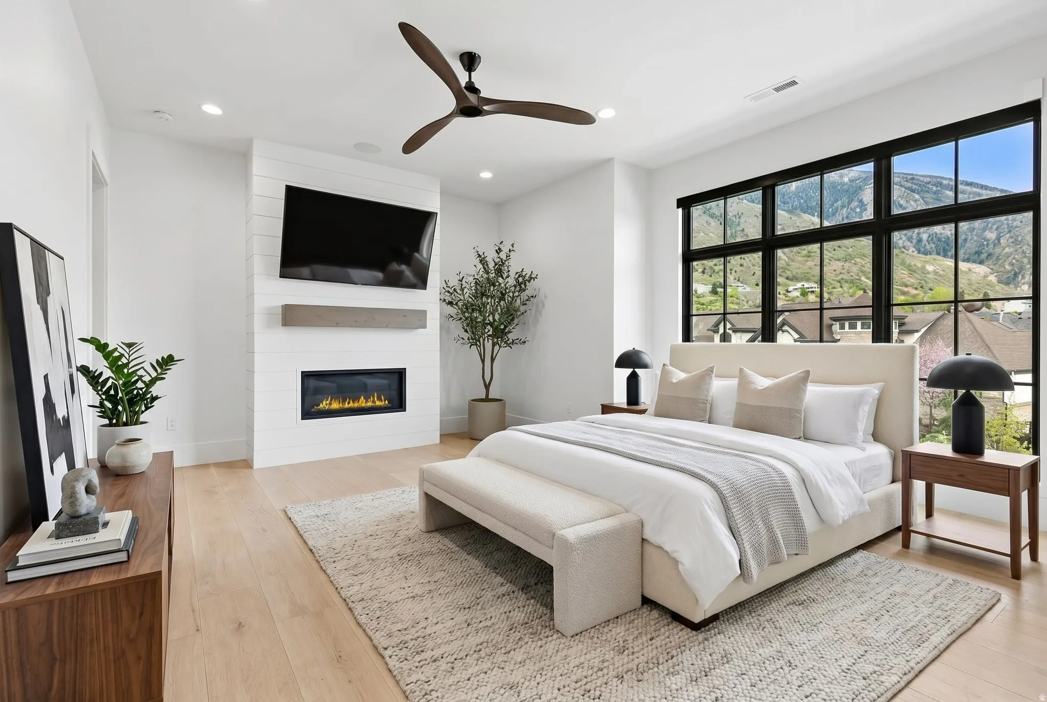 Bedroom with a ceiling fan, light wood-style flooring, a fireplace, and recessed lighting