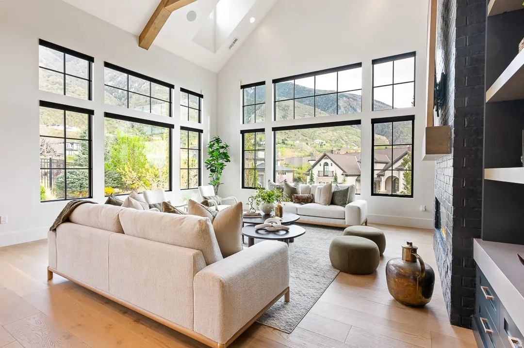 Living room featuring a fireplace, a skylight, light wood-style flooring, vaulted ceiling, and healthy amount of natural light