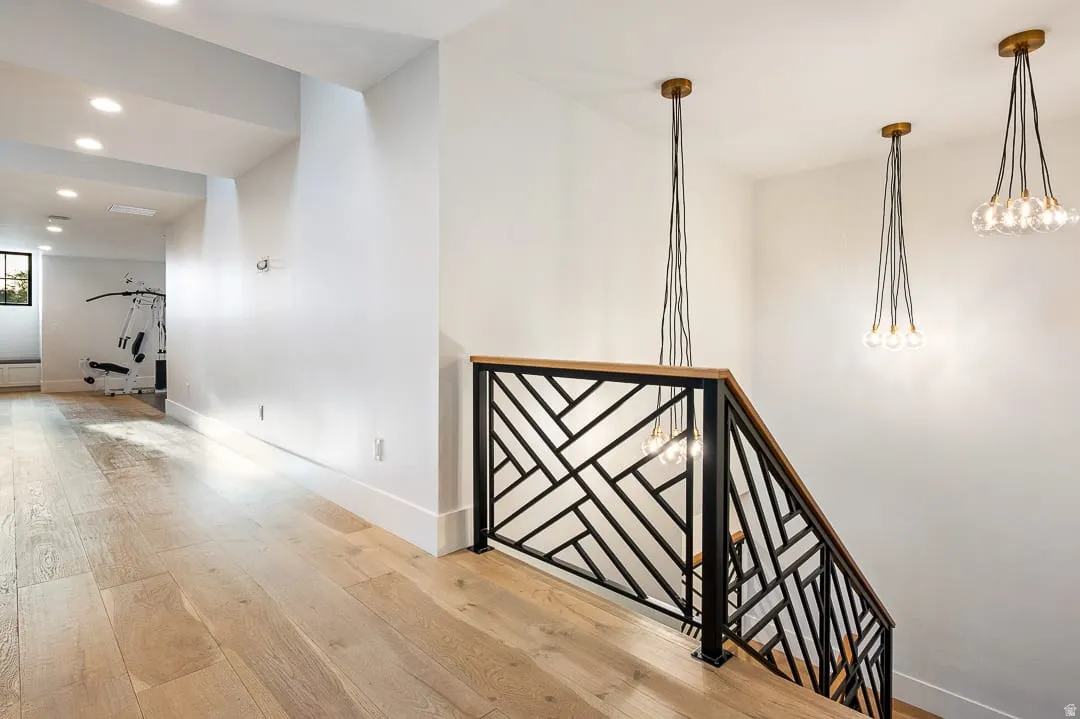 Stairway with hardwood / wood-style flooring and recessed lighting