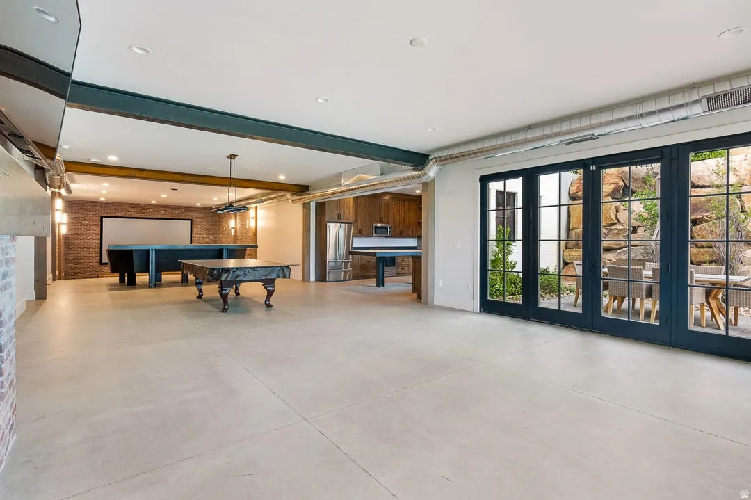 Playroom featuring billiards, beam ceiling, finished concrete floors, french doors, and recessed lighting