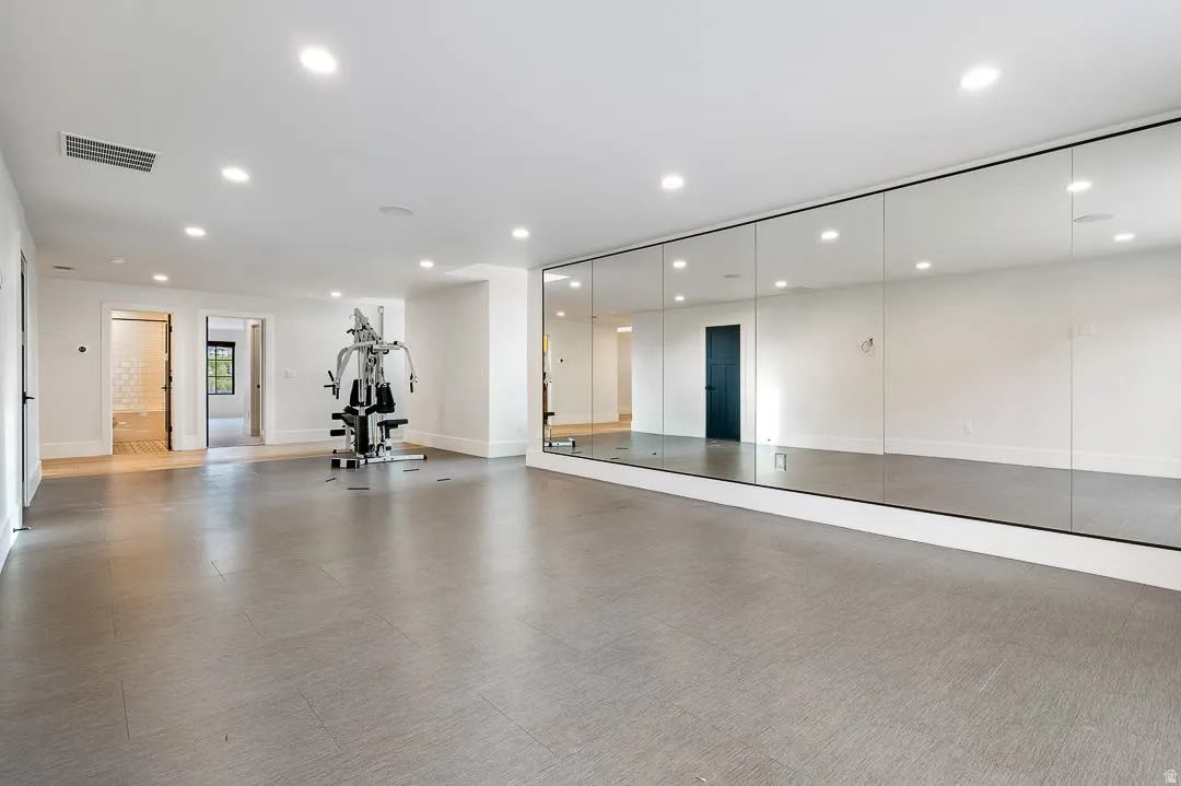 Workout room featuring recessed lighting