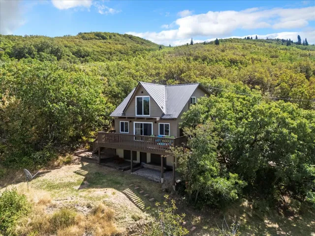 View of subject property with a heavily wooded area