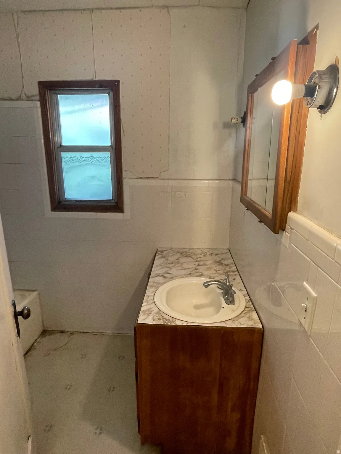 Full bathroom with tile walls and vanity