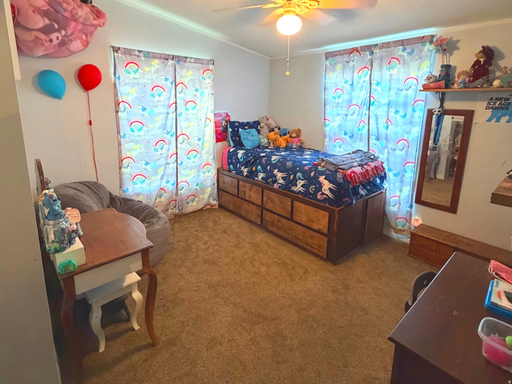 Bedroom featuring dark carpet, ceiling fan, and crown molding
