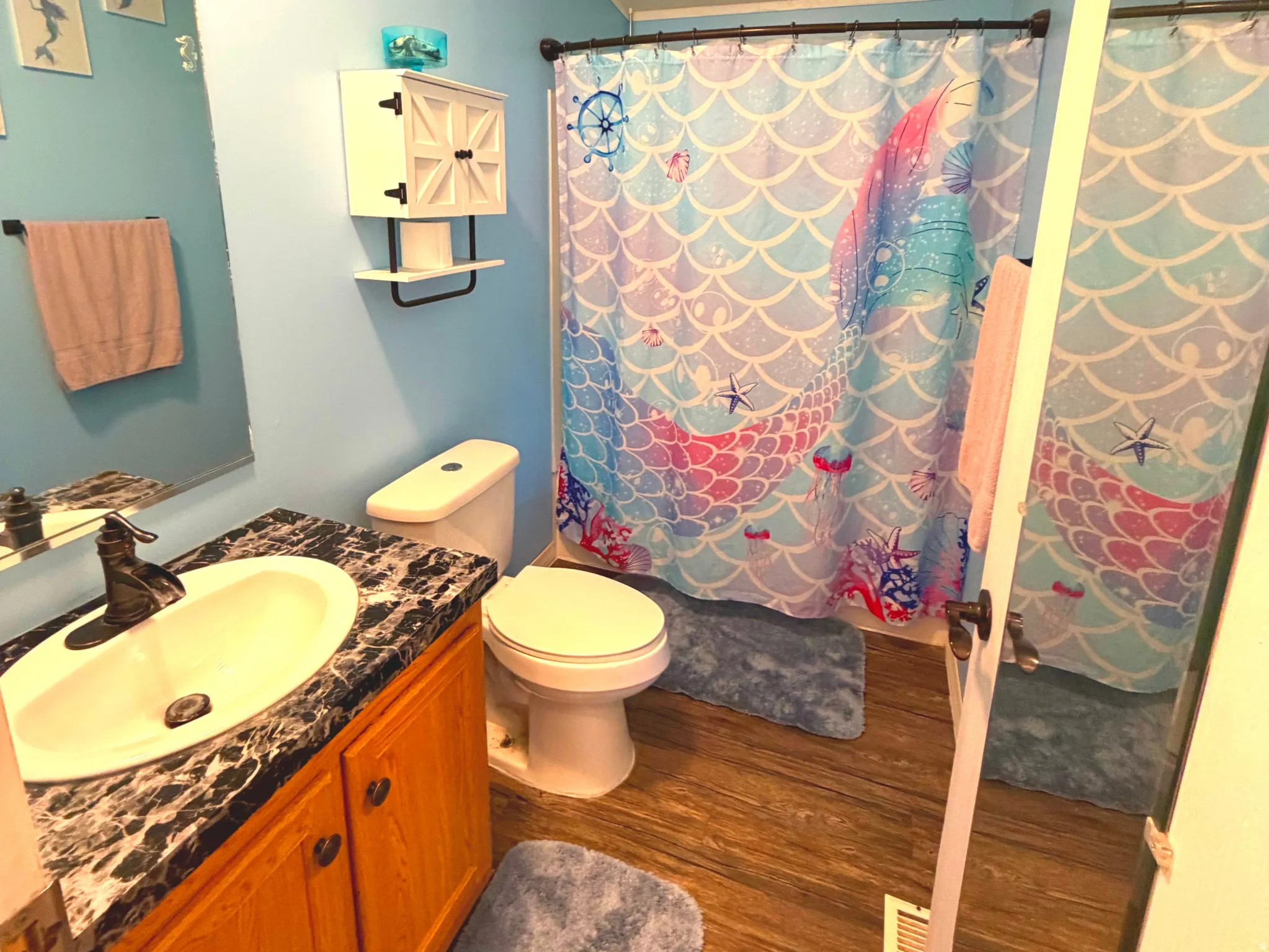 Bathroom featuring vanity, dark wood-type flooring, a textured ceiling, and ornamental molding
