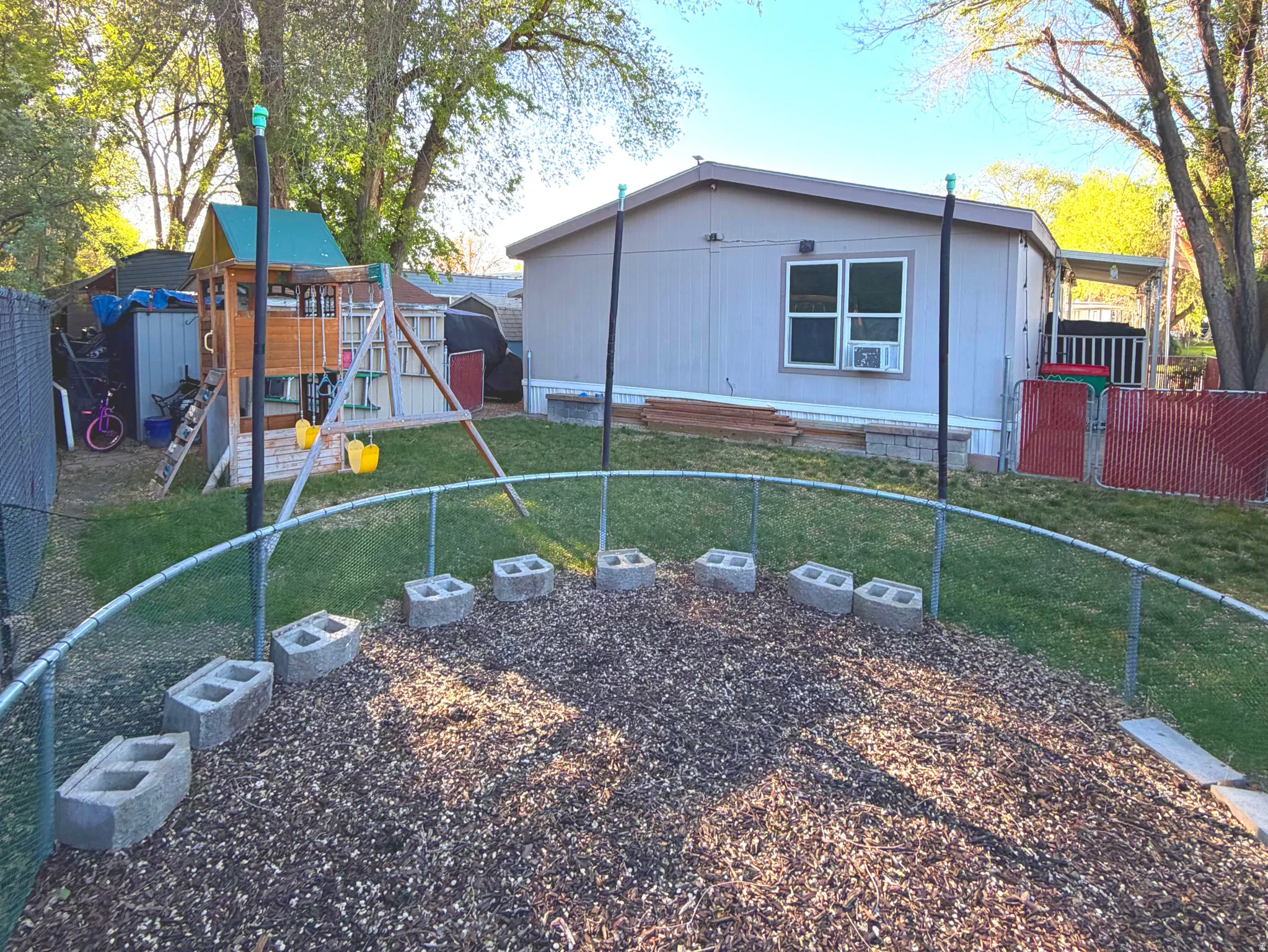 View of side of property featuring a fenced backyard and a playground