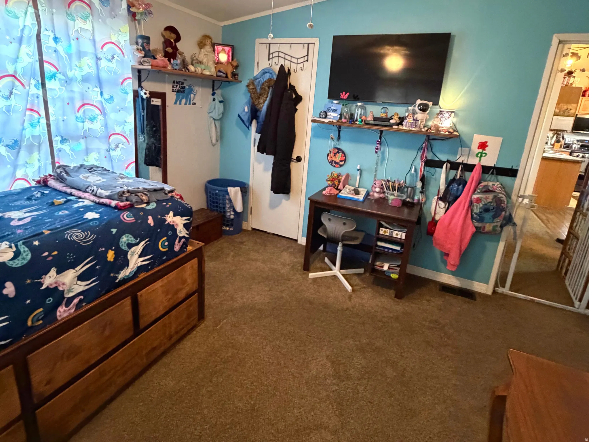 Bedroom featuring ceiling fan, dark colored carpet, and lofted ceiling