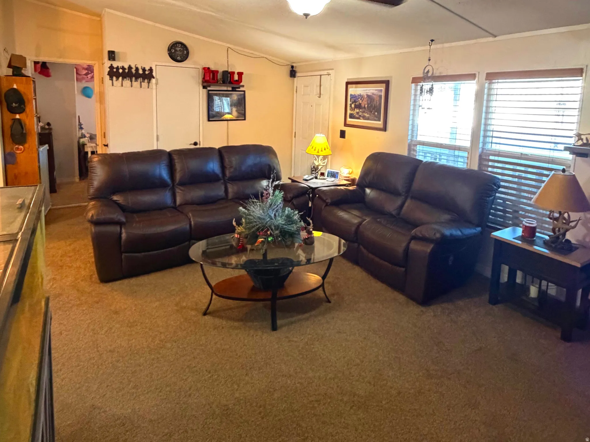 Living area featuring carpet flooring and vaulted ceiling
