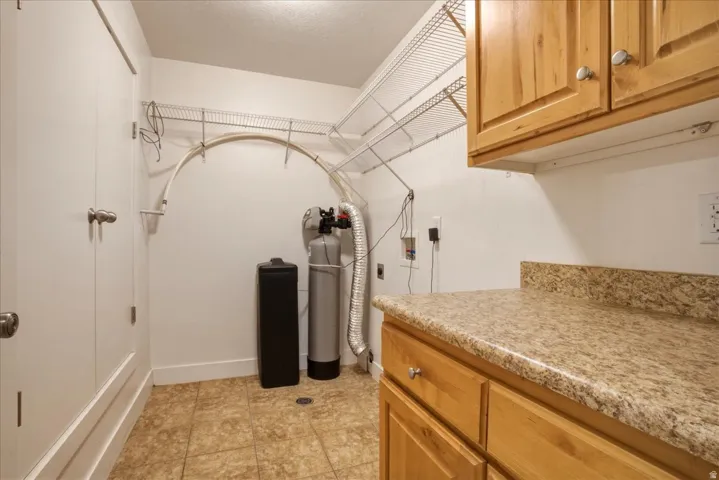 Laundry Room with Hookup for a Washing Machine, Plenty of  Cabinet Space, Electric Dryer Hookup and Water Softener.