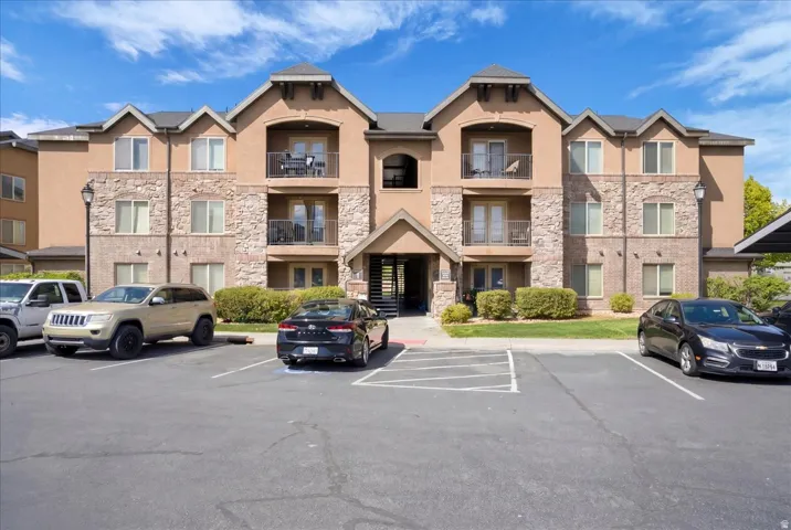 View of condo building. Plenty of parking including one assigned covered spot.