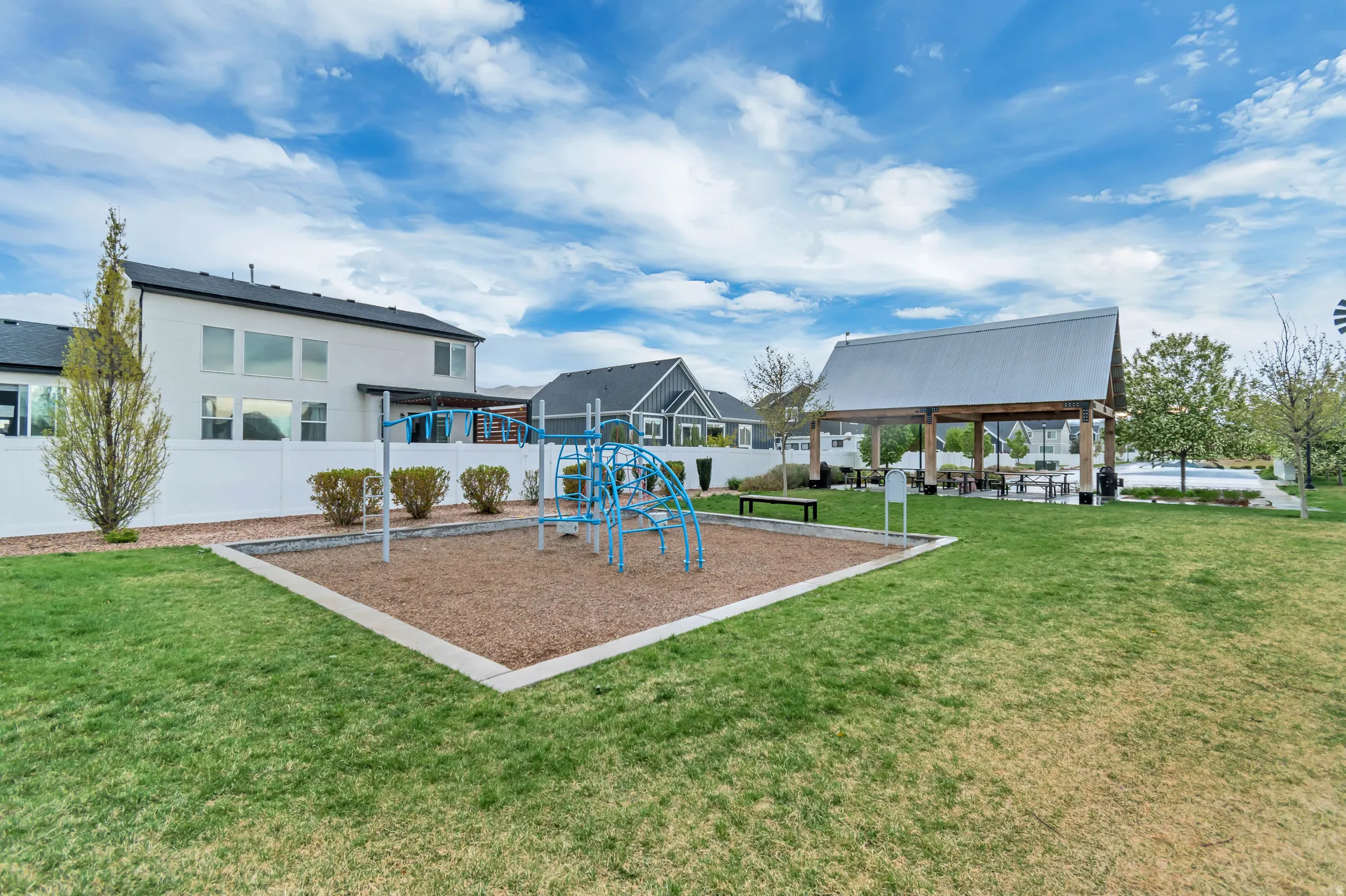 Community playground with a yard and a patio