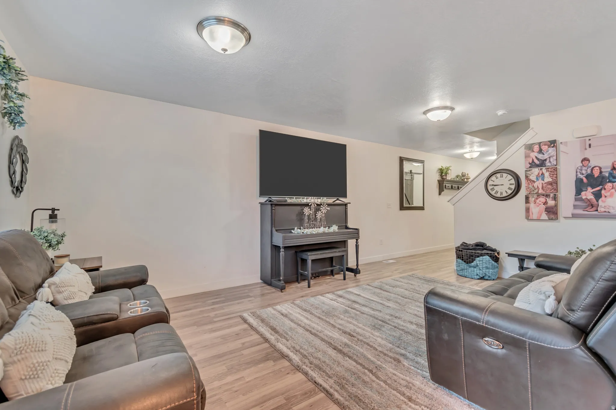 Living room with light wood-style floors and baseboards