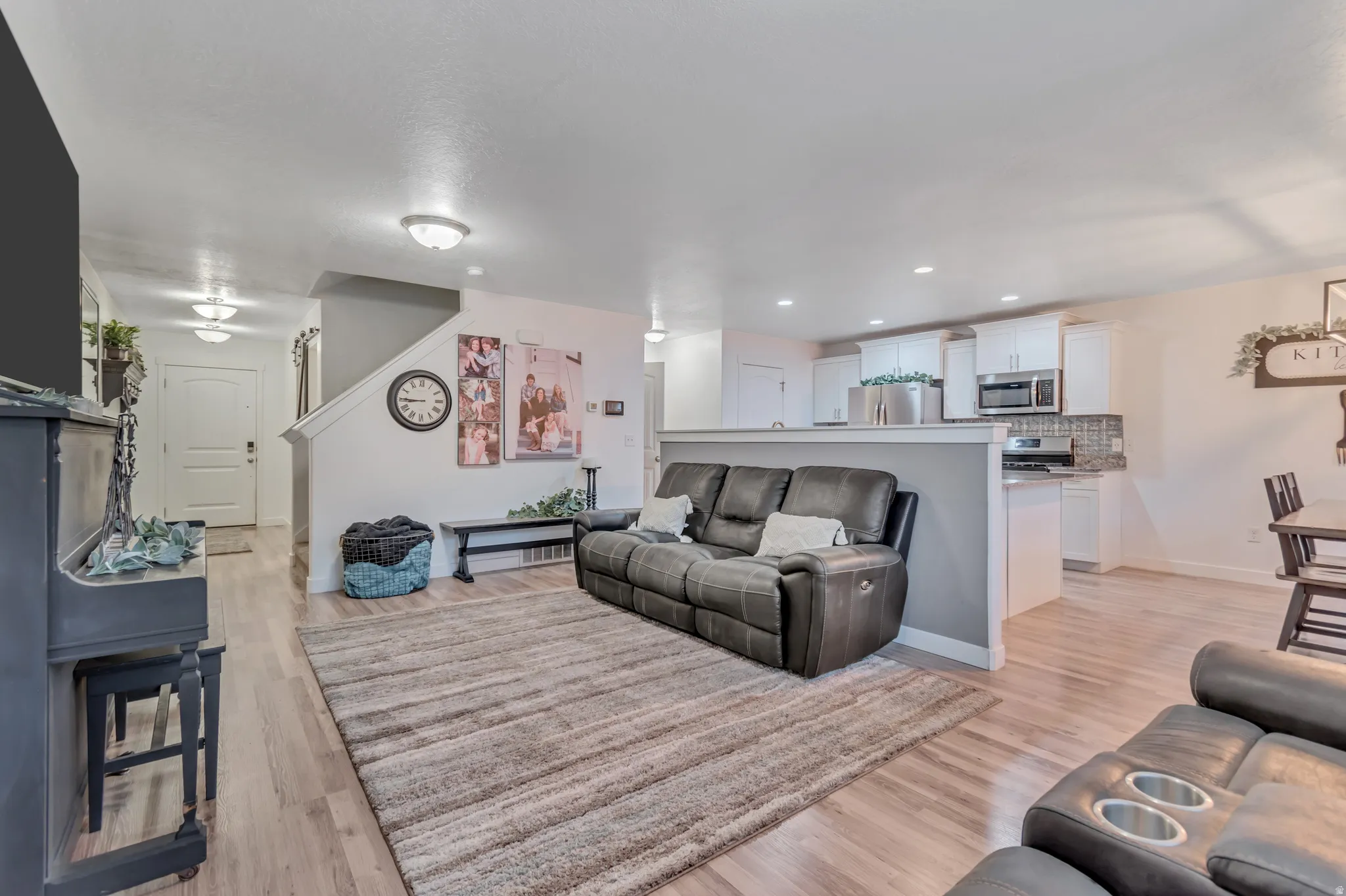 Living room with light wood-style floors and recessed lighting