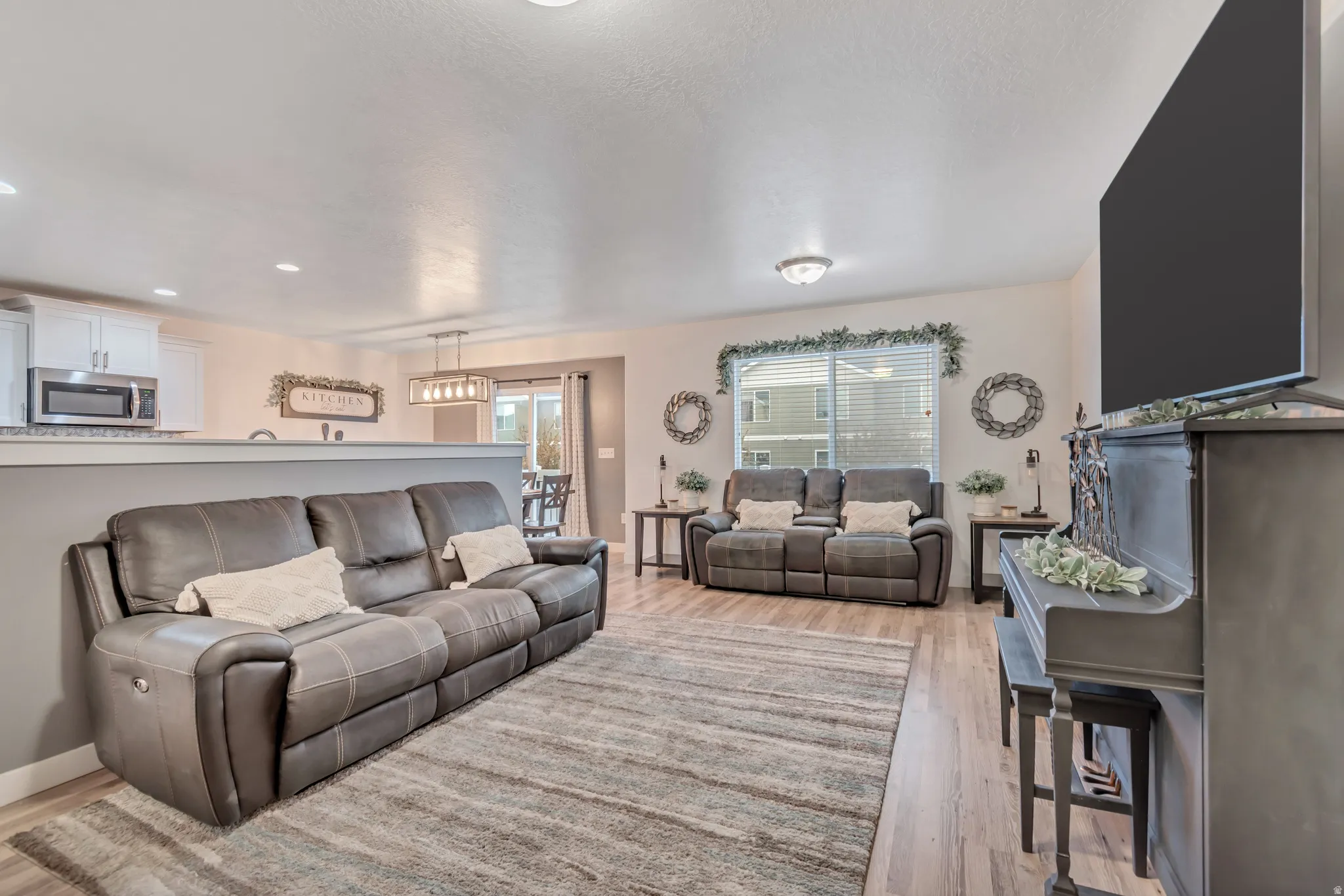 Living room featuring light wood-type flooring and recessed lighting