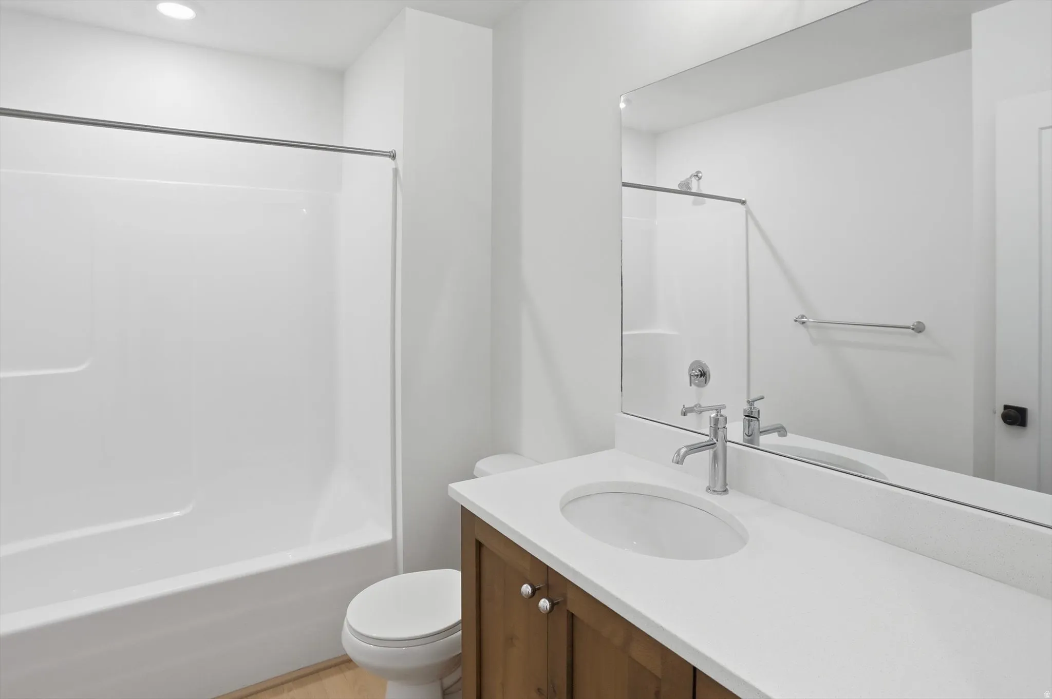 Bathroom featuring vanity, shower / bath combination, and recessed lighting