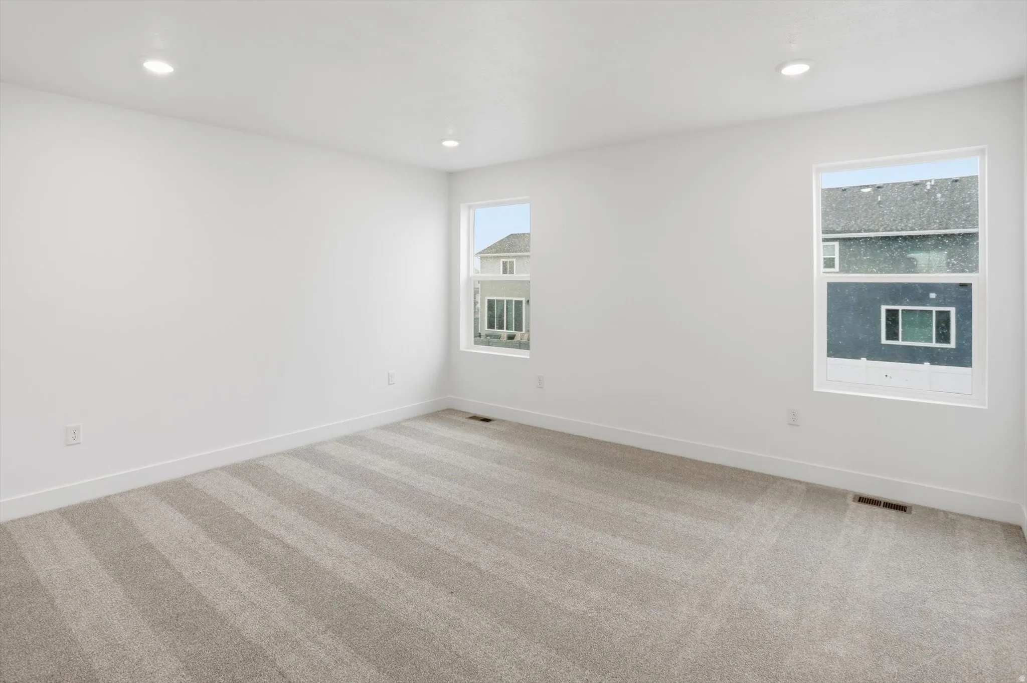 Unfurnished room featuring carpet and recessed lighting