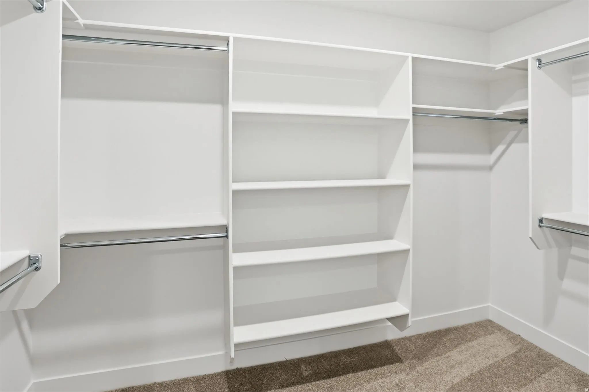 Walk in closet with light carpet
