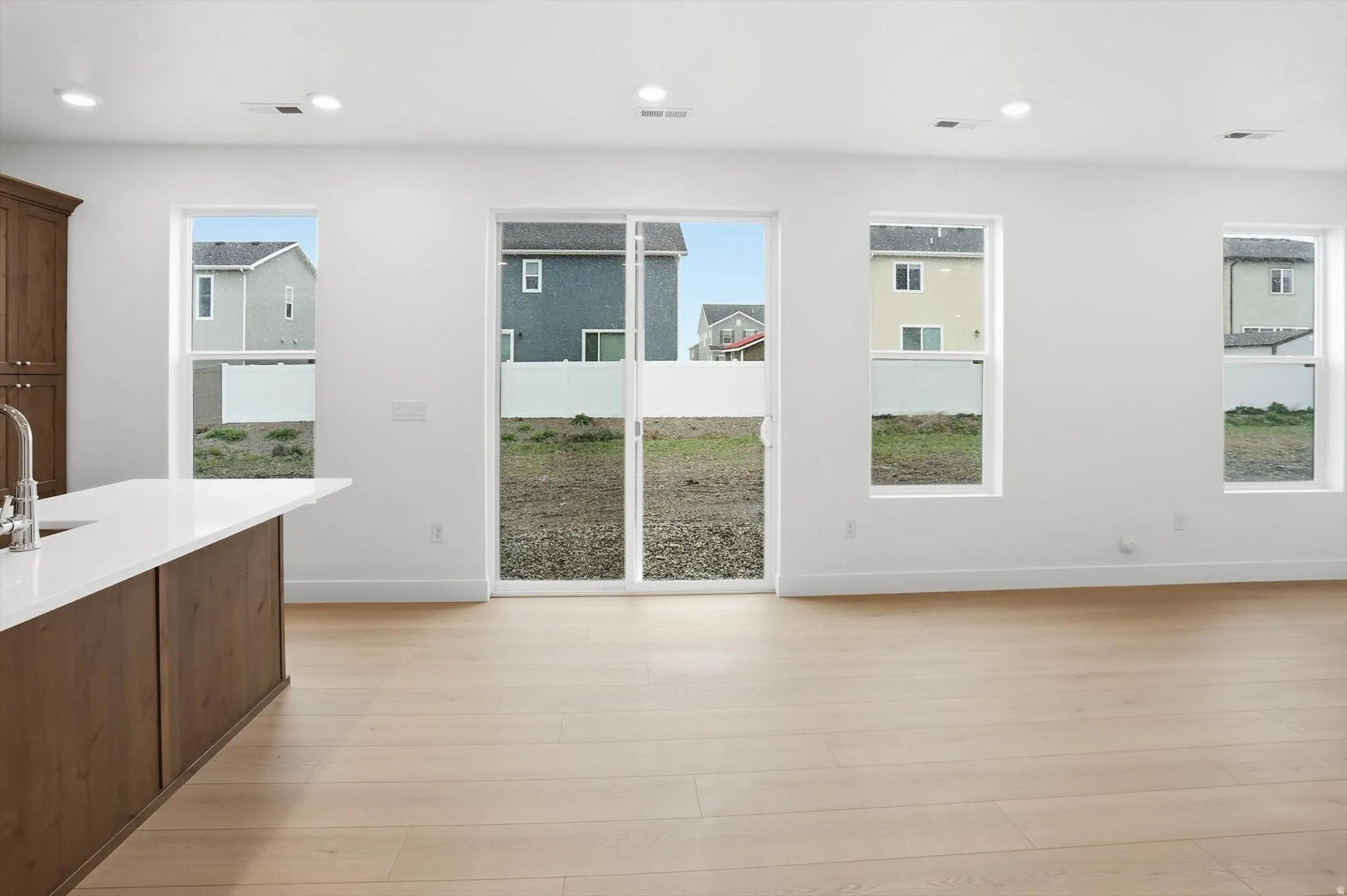 Unfurnished dining area featuring light wood-type flooring and recessed lighting