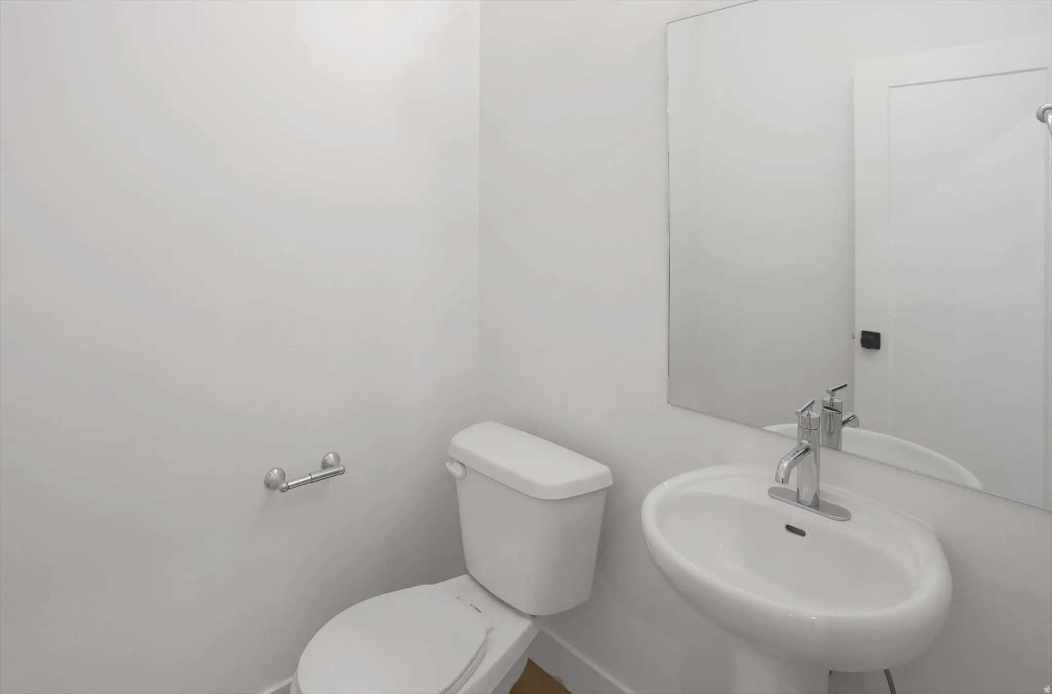 Half bath with toilet and a sink